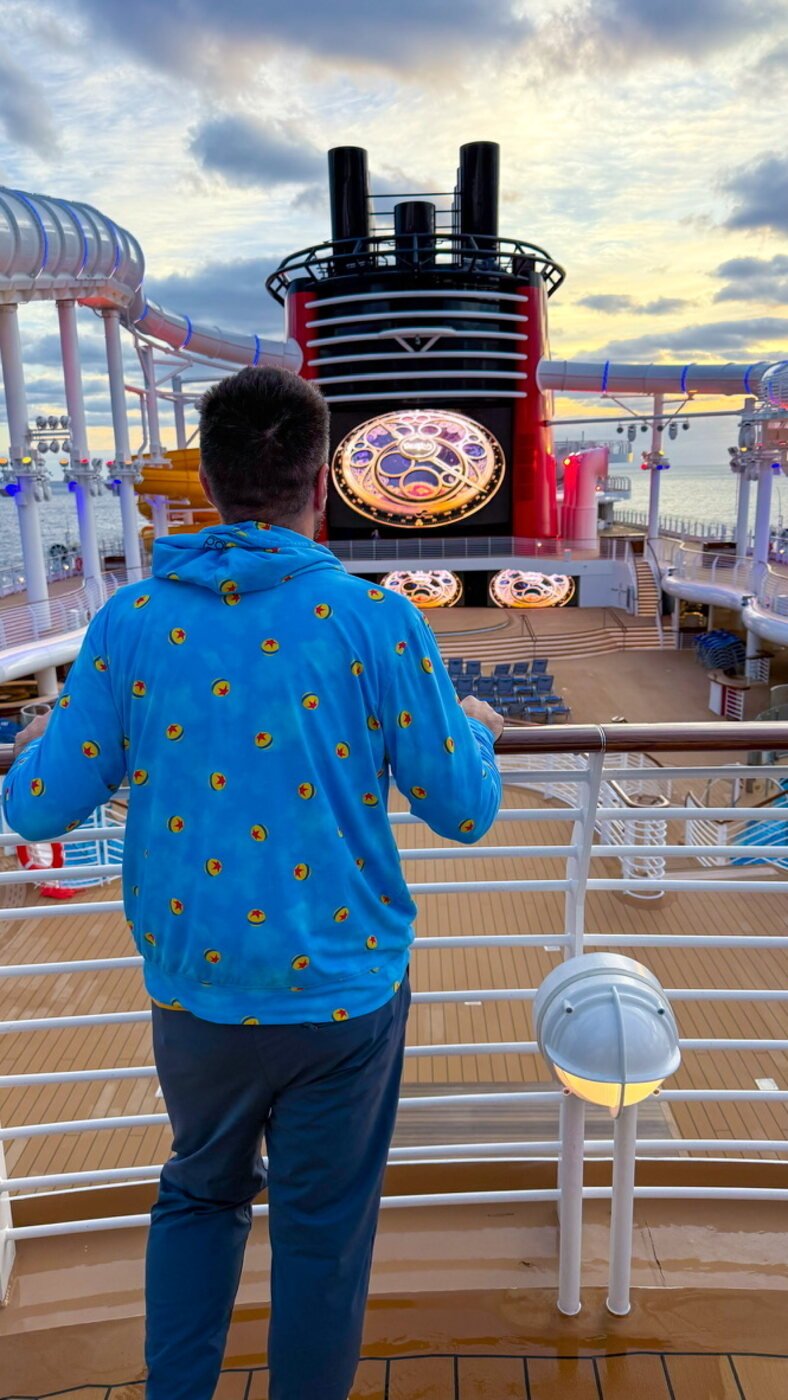 A Sandpiper Vacations travel advisor on the top deck of a Disney Cruise Line ship