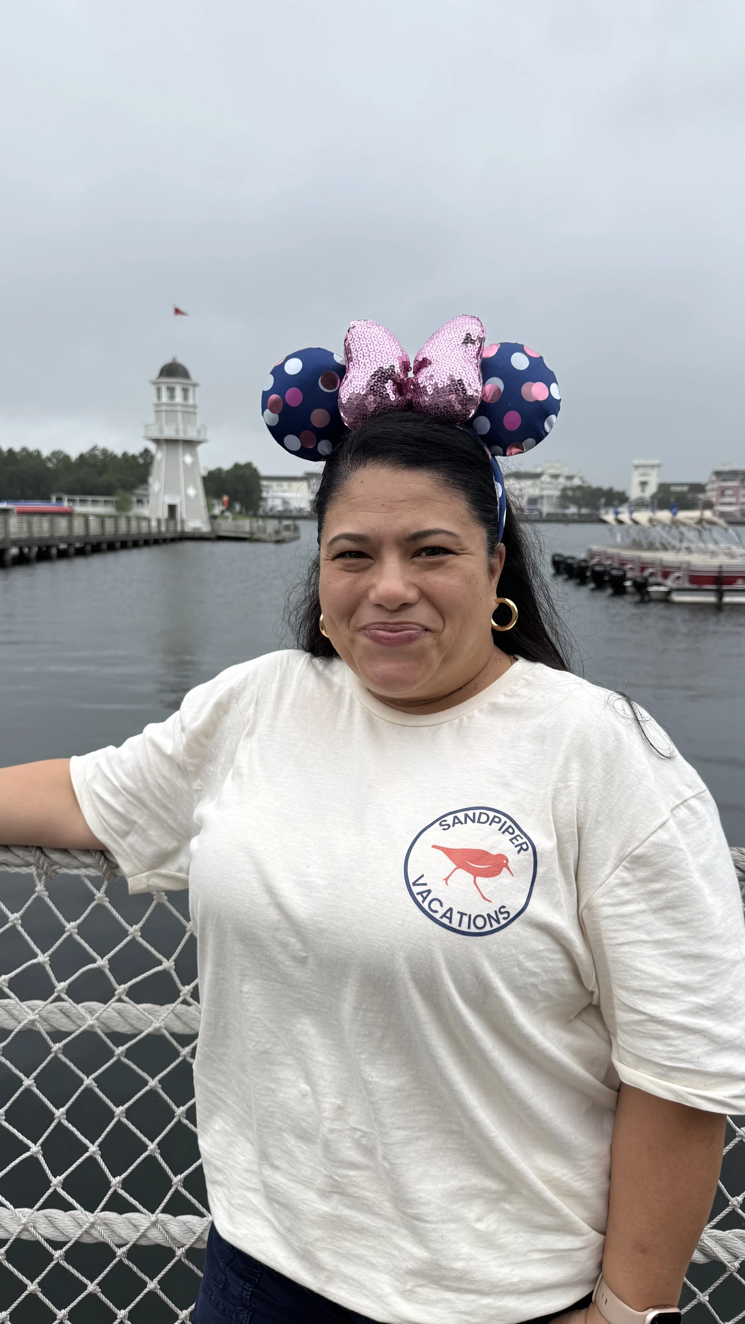 A hot air balloon with multicolor panels and a logo, floating in a clear blue sky.