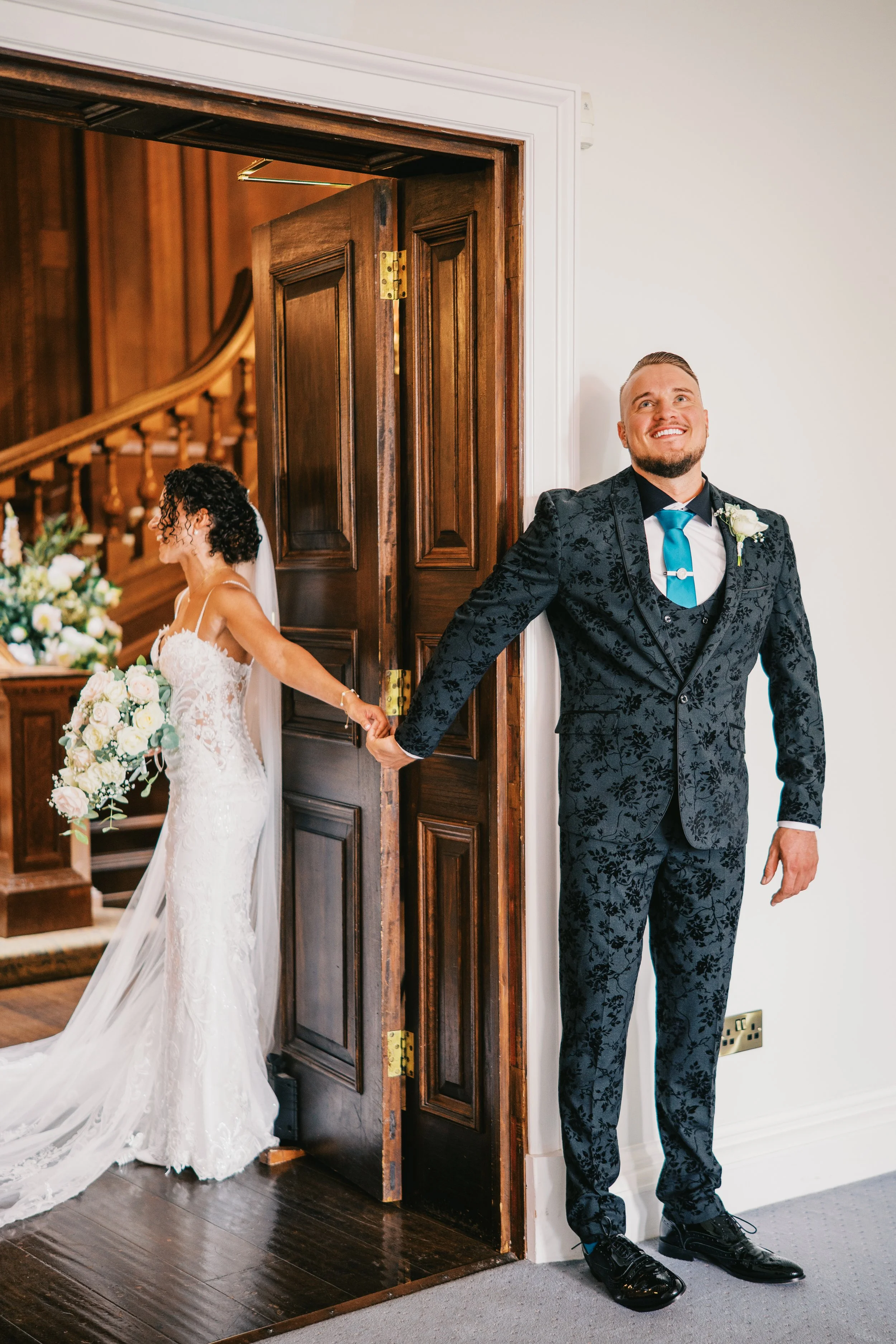 first touch moment between a bride and groom at Bourton Hall wedding venue