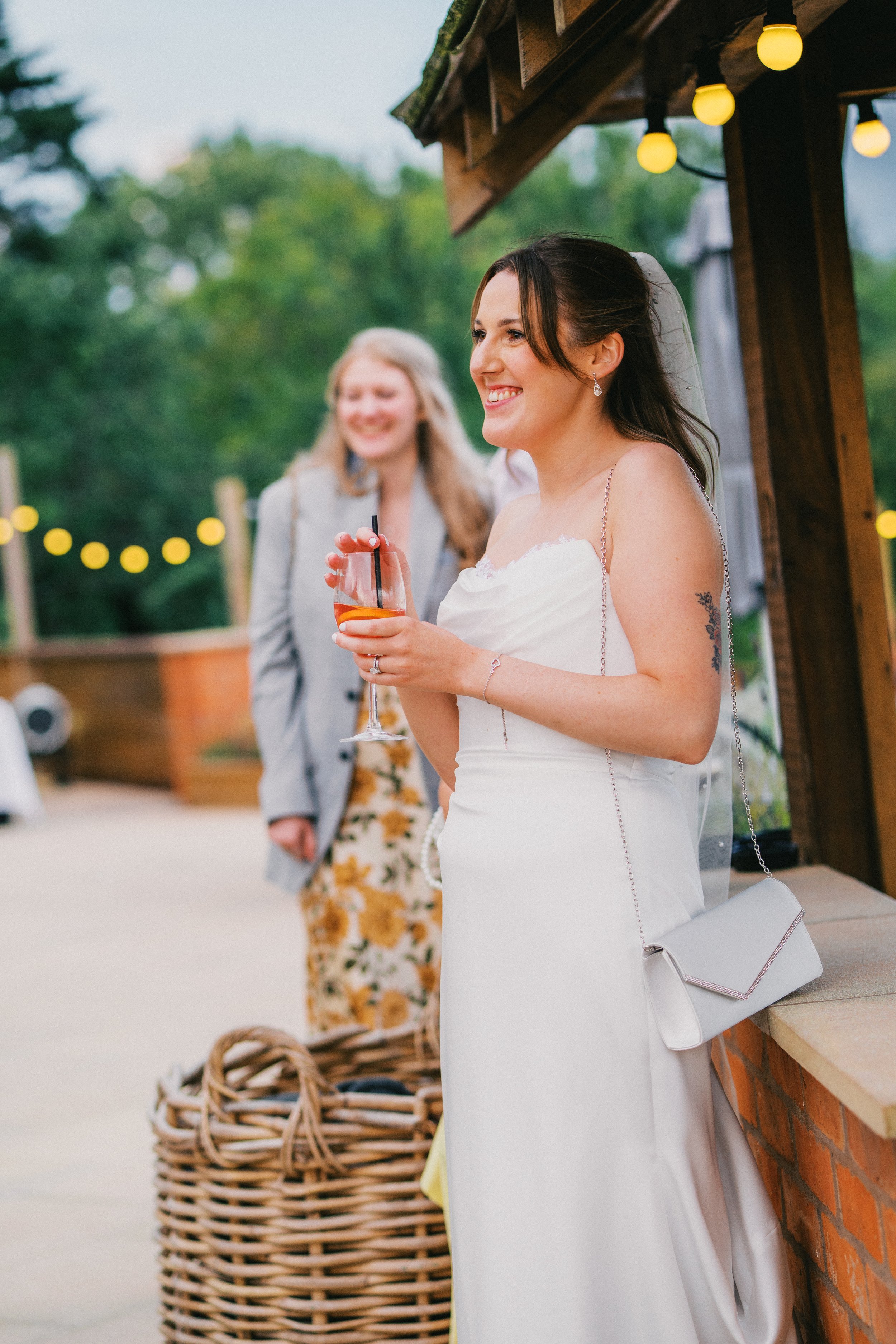 bride smiling casually while listening to speeches