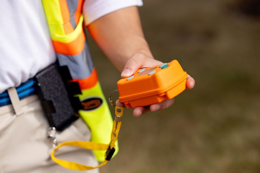 Worker in high-vis vest using Wireless Kill Switch