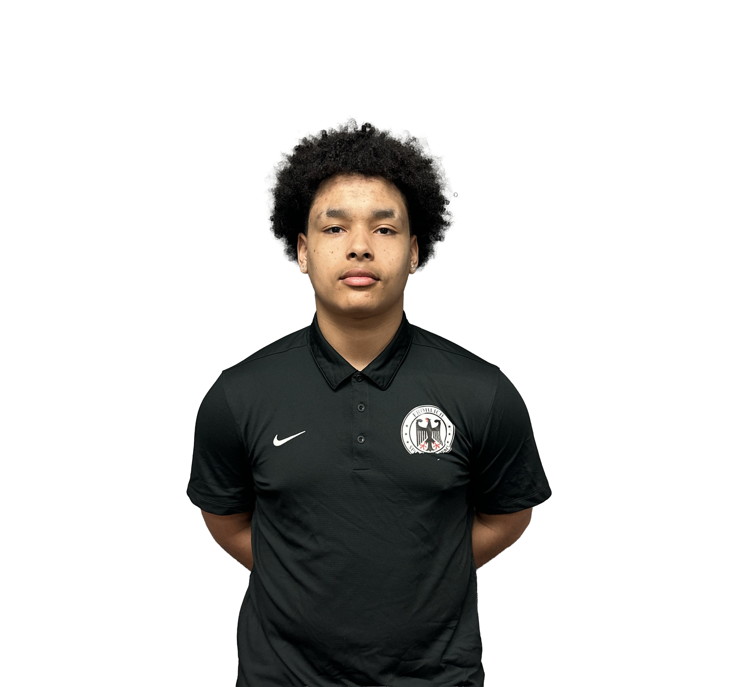 A young man with curly black hair and earrings, wearing a black sports jersey with the German national team logo, standing against a plain background.