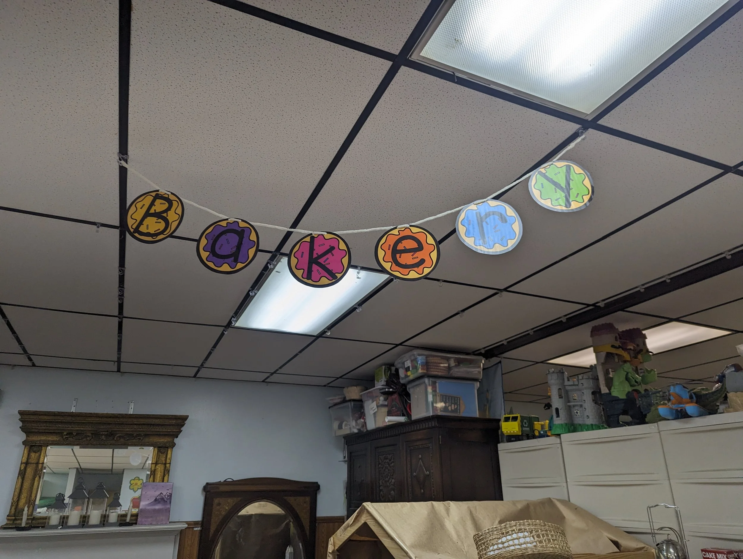 Decorative banner spelling out 'bakery' hanging from the ceiling.