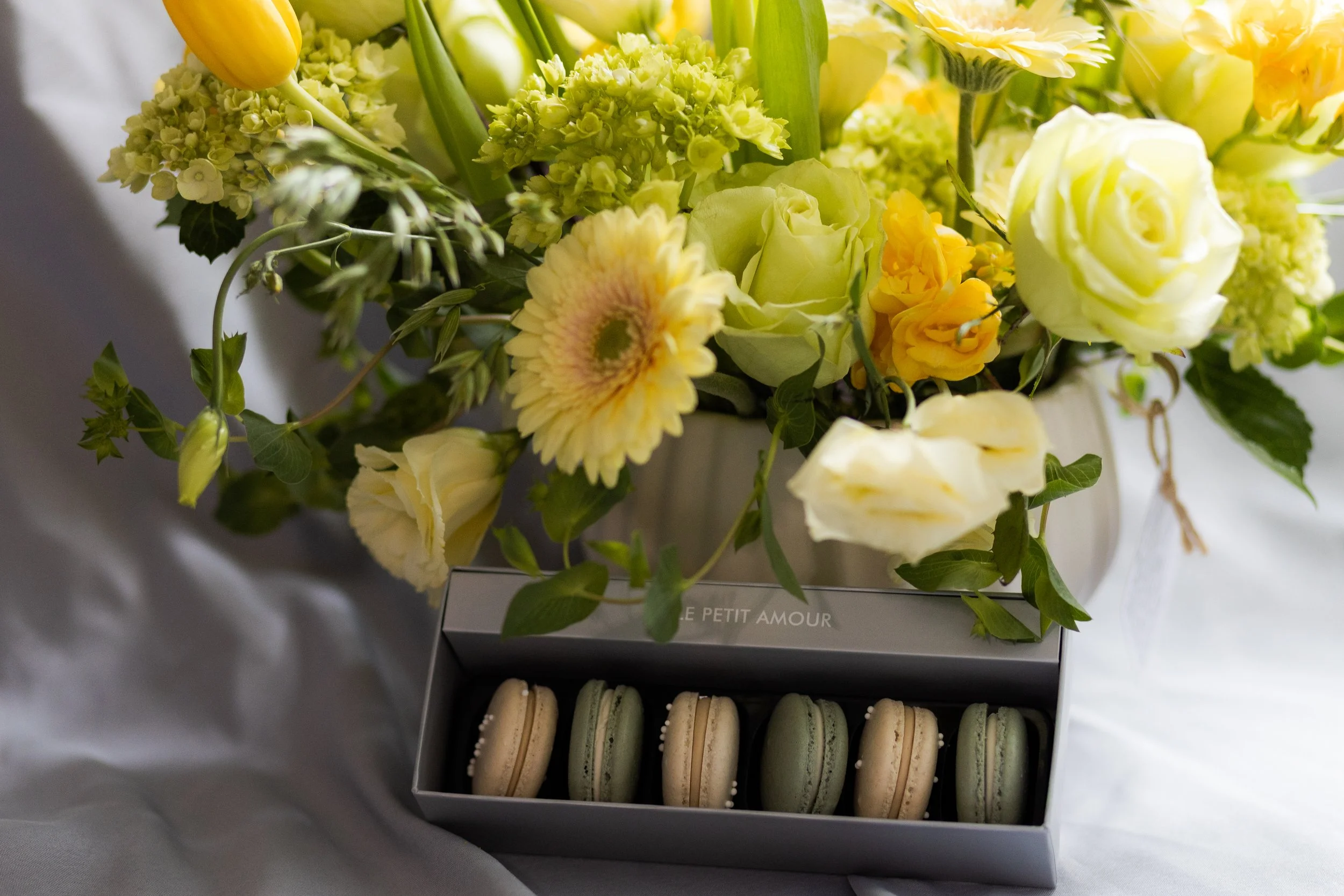 Yellow floral bouquet and Le Petit Amour macaron box