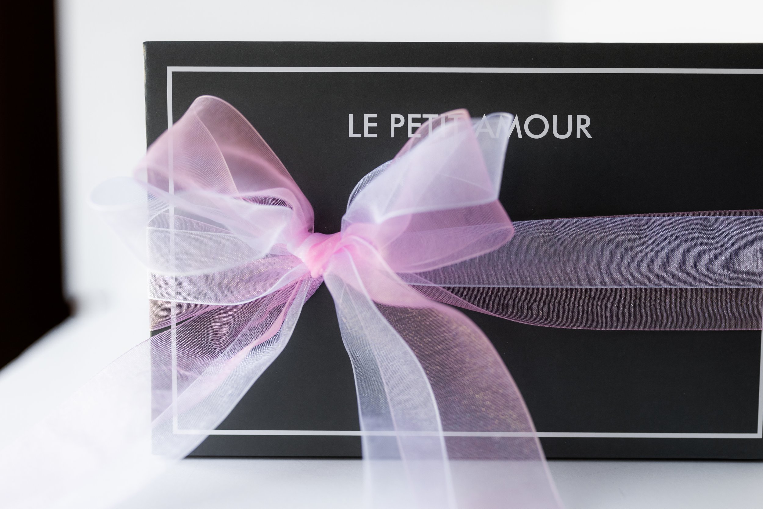 Dark gray Le Petit Amour gift box with a pink bow