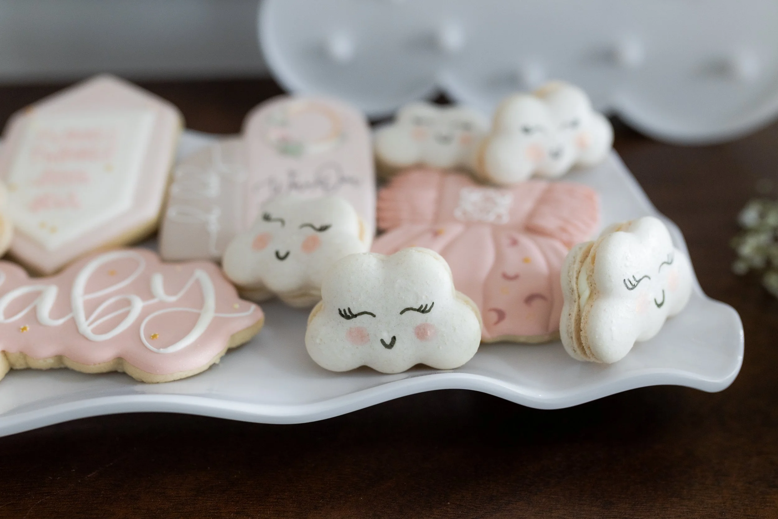 Custom macarons in the shape of a cloud with a smiley face