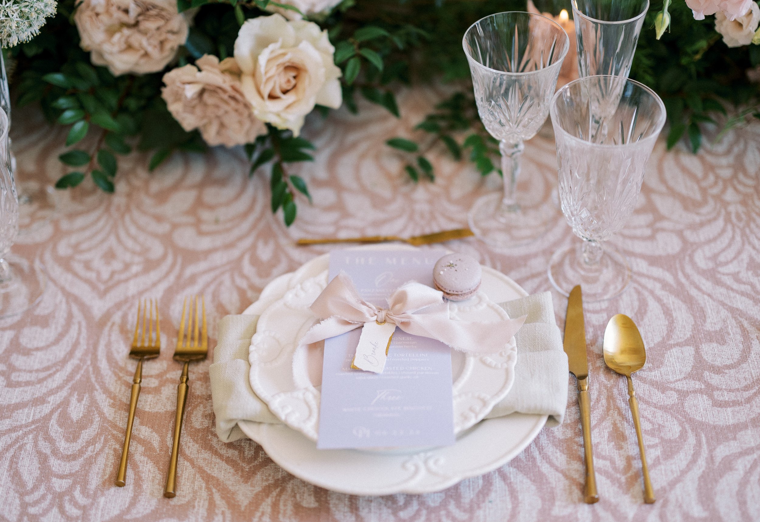 Wedding table scape with a macaron on the plate