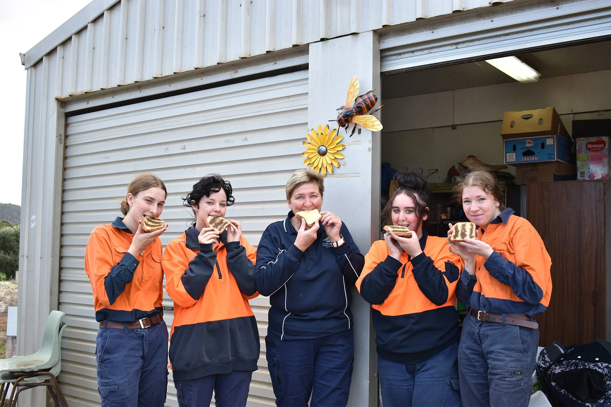 Mrs Dufall and students eating honey bread.JPG