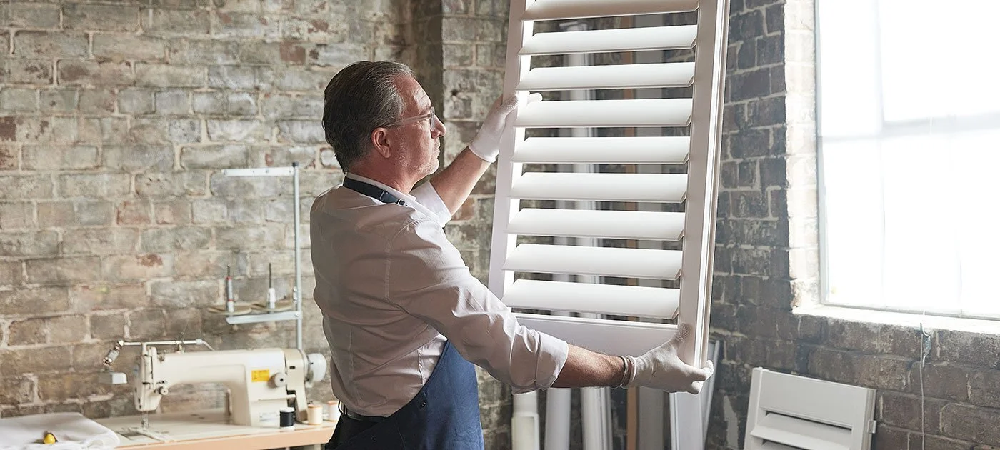 Australian-made PolySatin plantation shutters being inspected during quality control for Sun Solutions. Custom indoor shutters Perth for homes and businesses