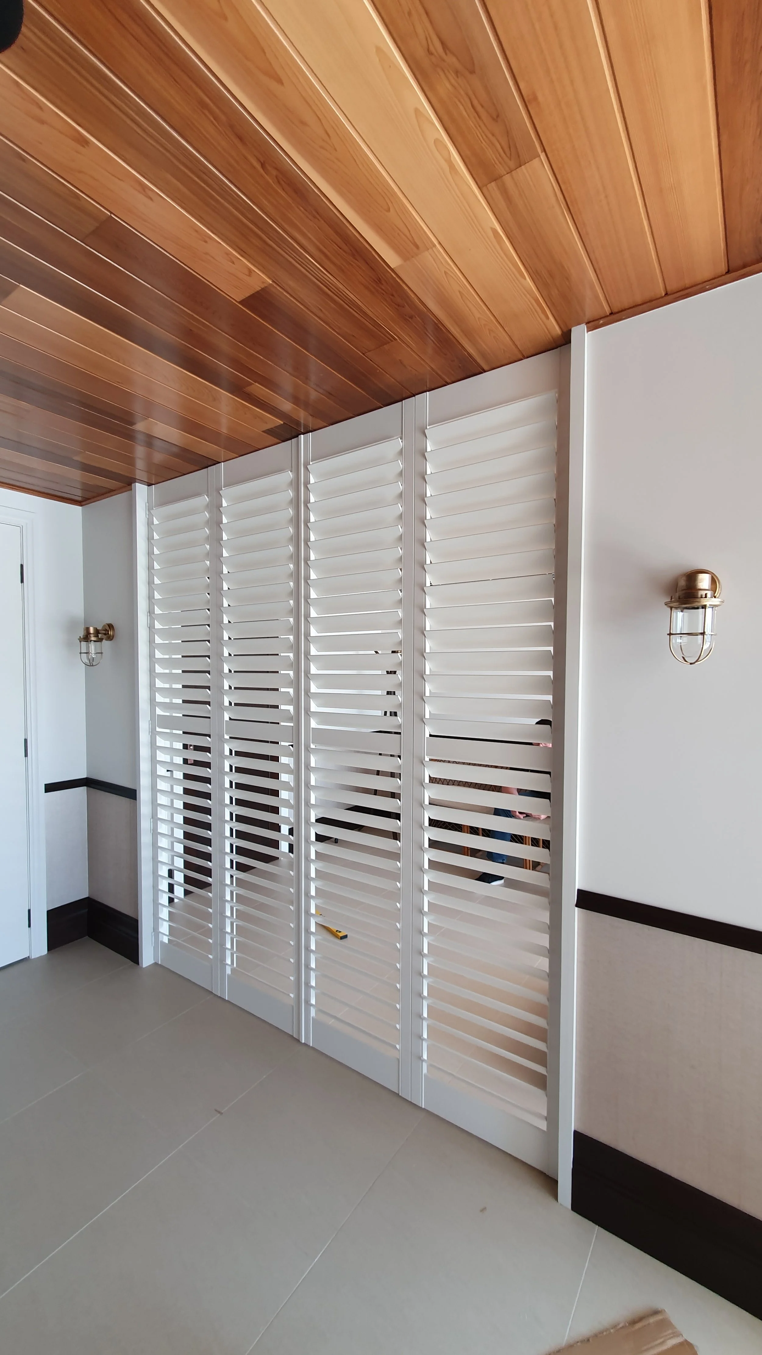 White PolySatin Shutters providing privacy on a bi-fold door at a home in Perth