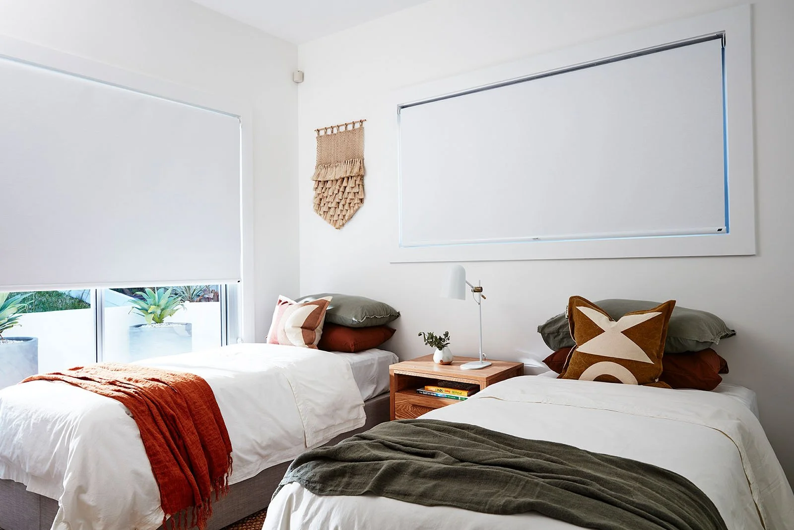 Blockout roller blinds in white in Perth bedroom showing edge light gaps around perimeter with standard installation