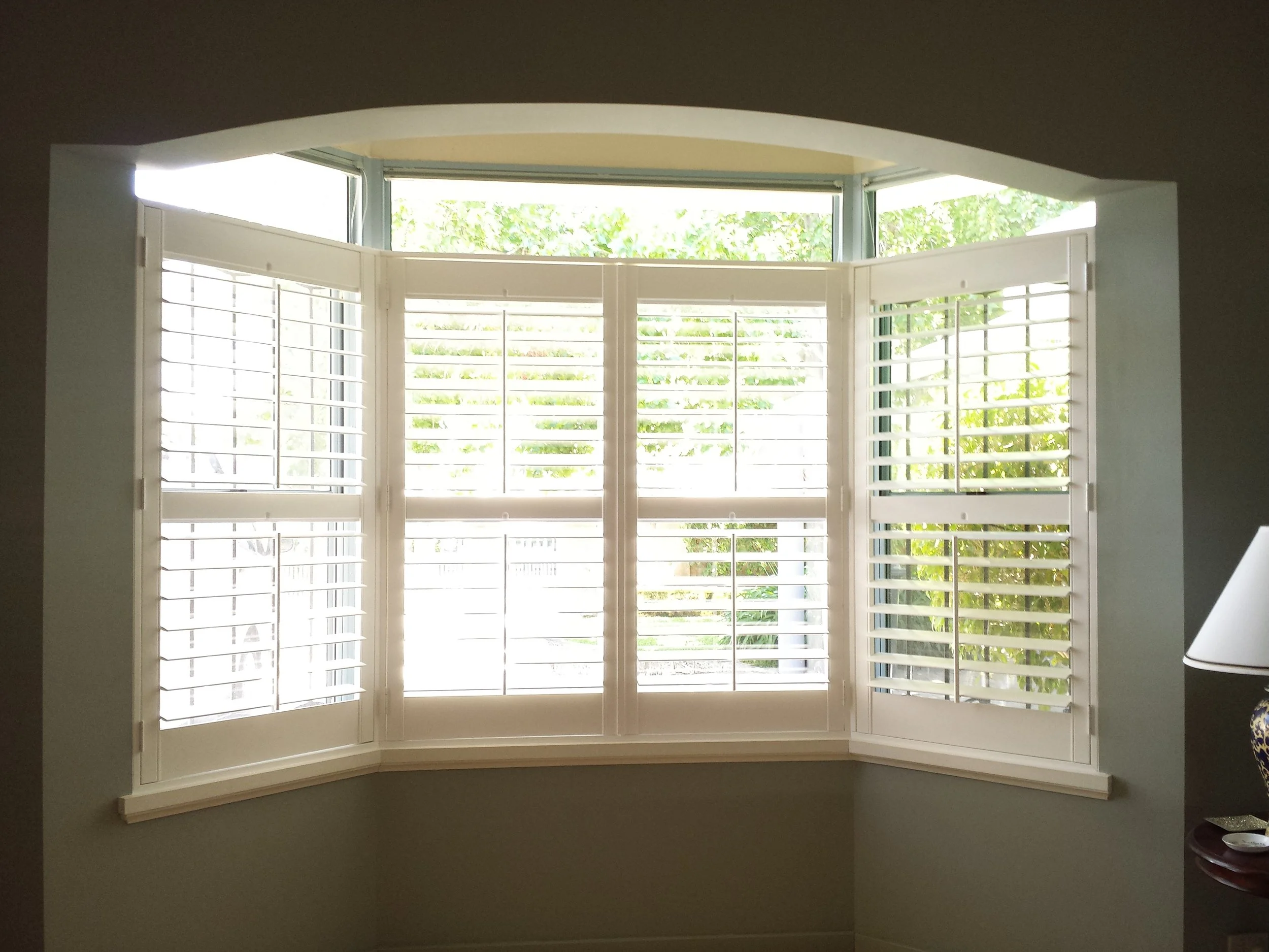 PolySatin Plantation Shutters featured in a bay window.  Suitable for heritage-style homes and offices.
