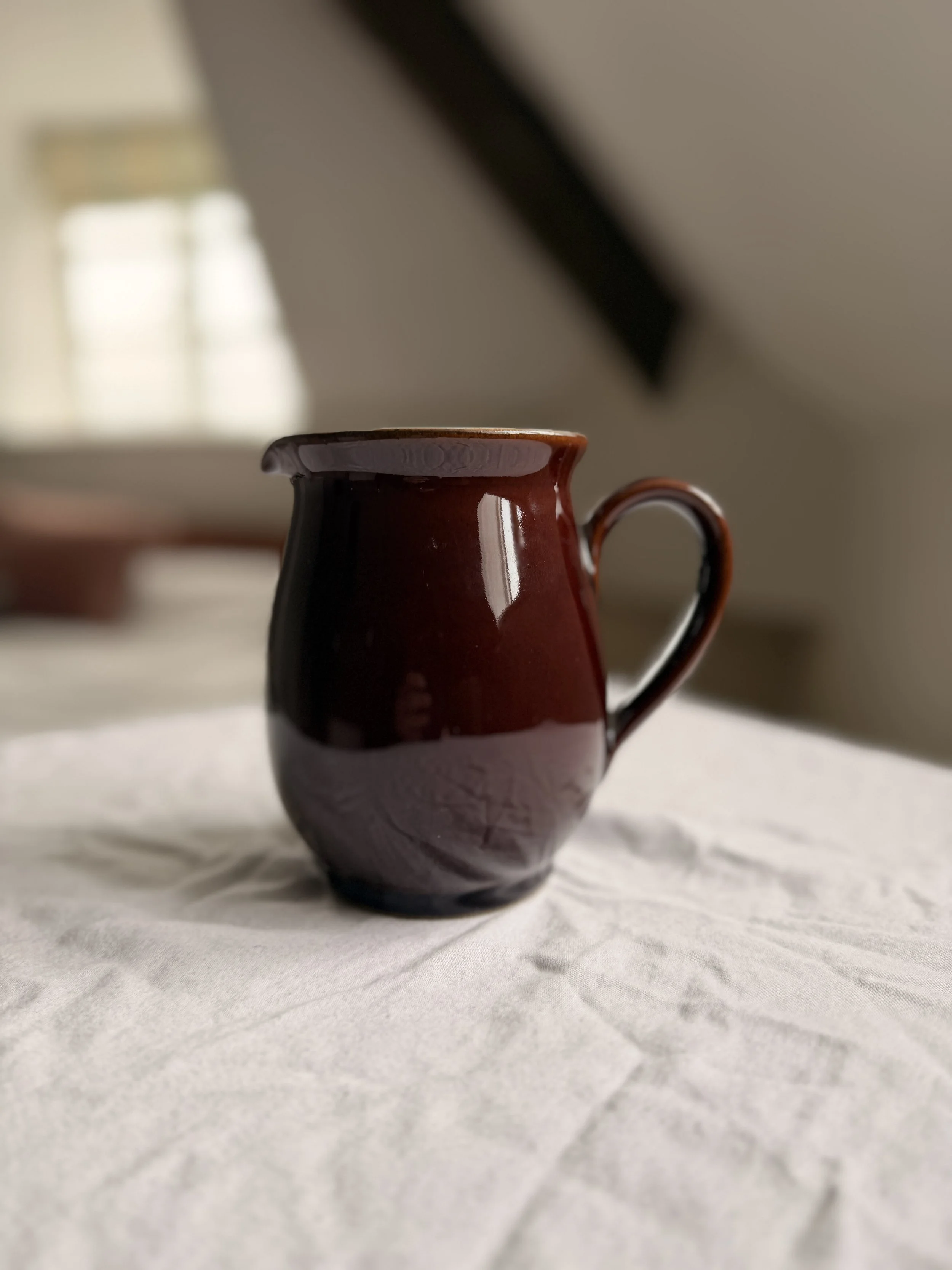 intage 1950s Denby Homestead Brown stoneware jug with a glossy chocolate brown exterior and a pale sky blue interior.