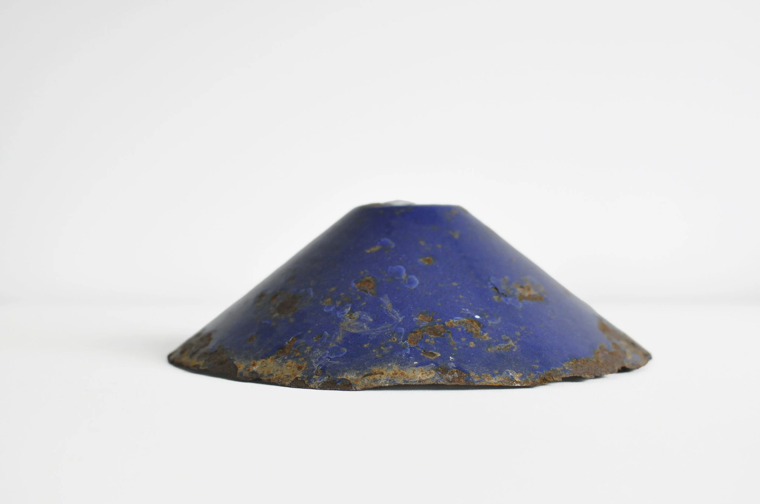 Industrial salvage blue enamel light shade for rustic kitchen styling.