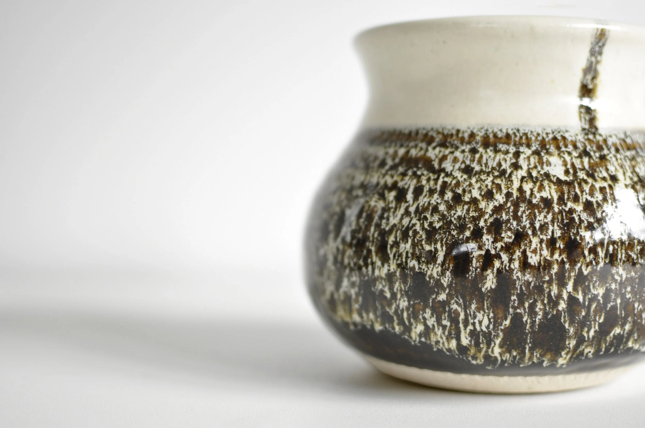 Close-up of earth-brown mottled glaze on British studio pottery.