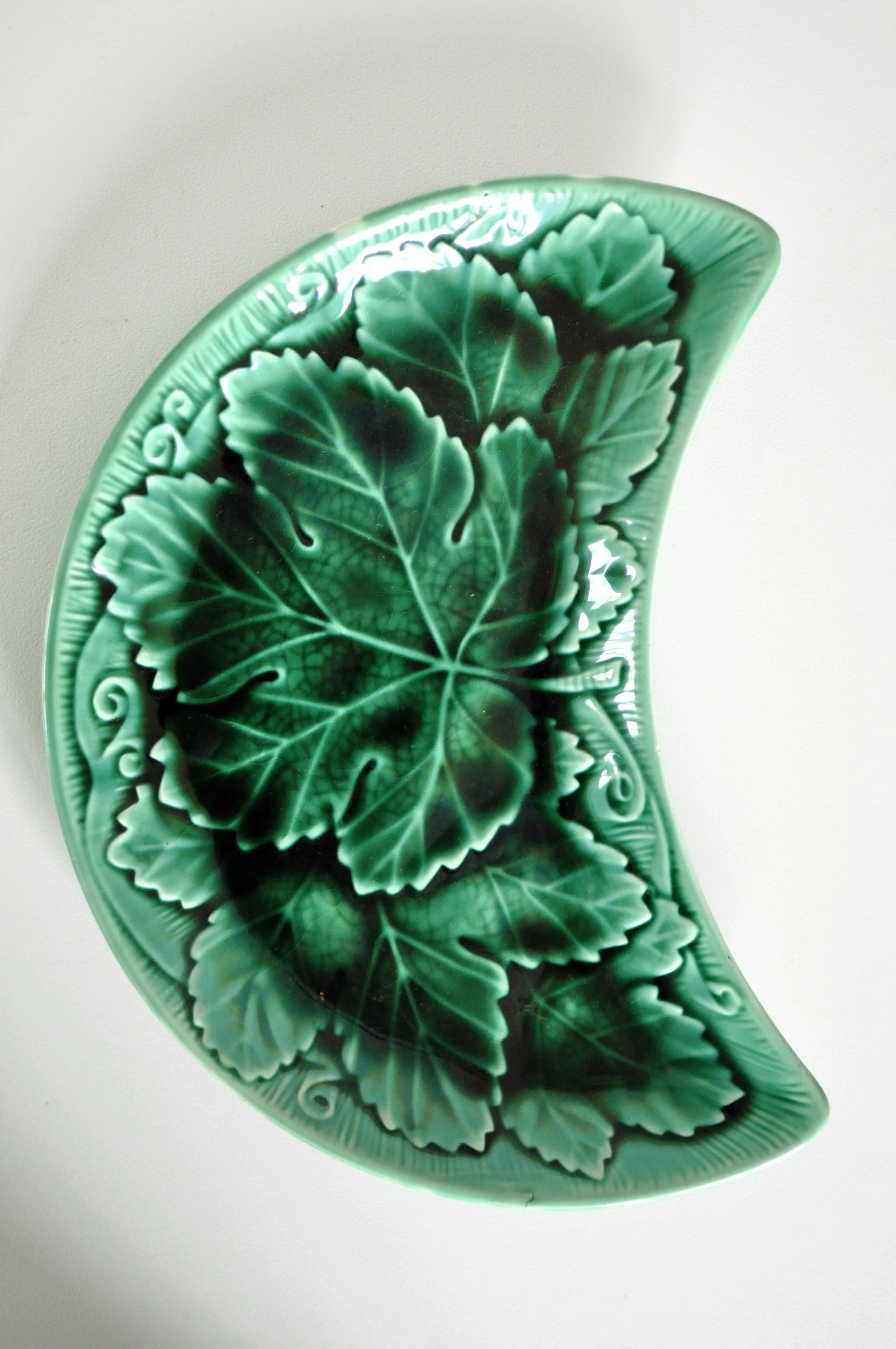 Close-up of leaf texture and green glaze on vintage Wedgwood pottery.