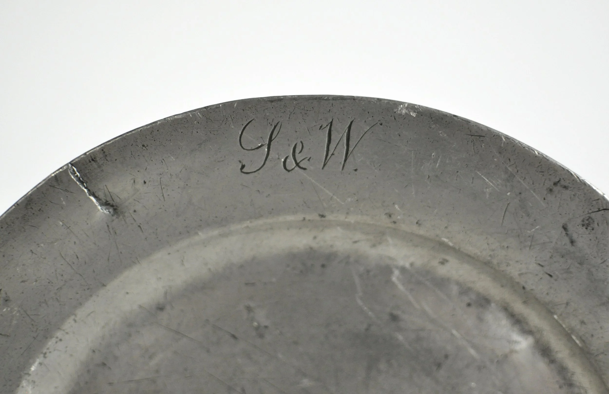 Antique 18th century London pewter plate with S&W monogram on rim.