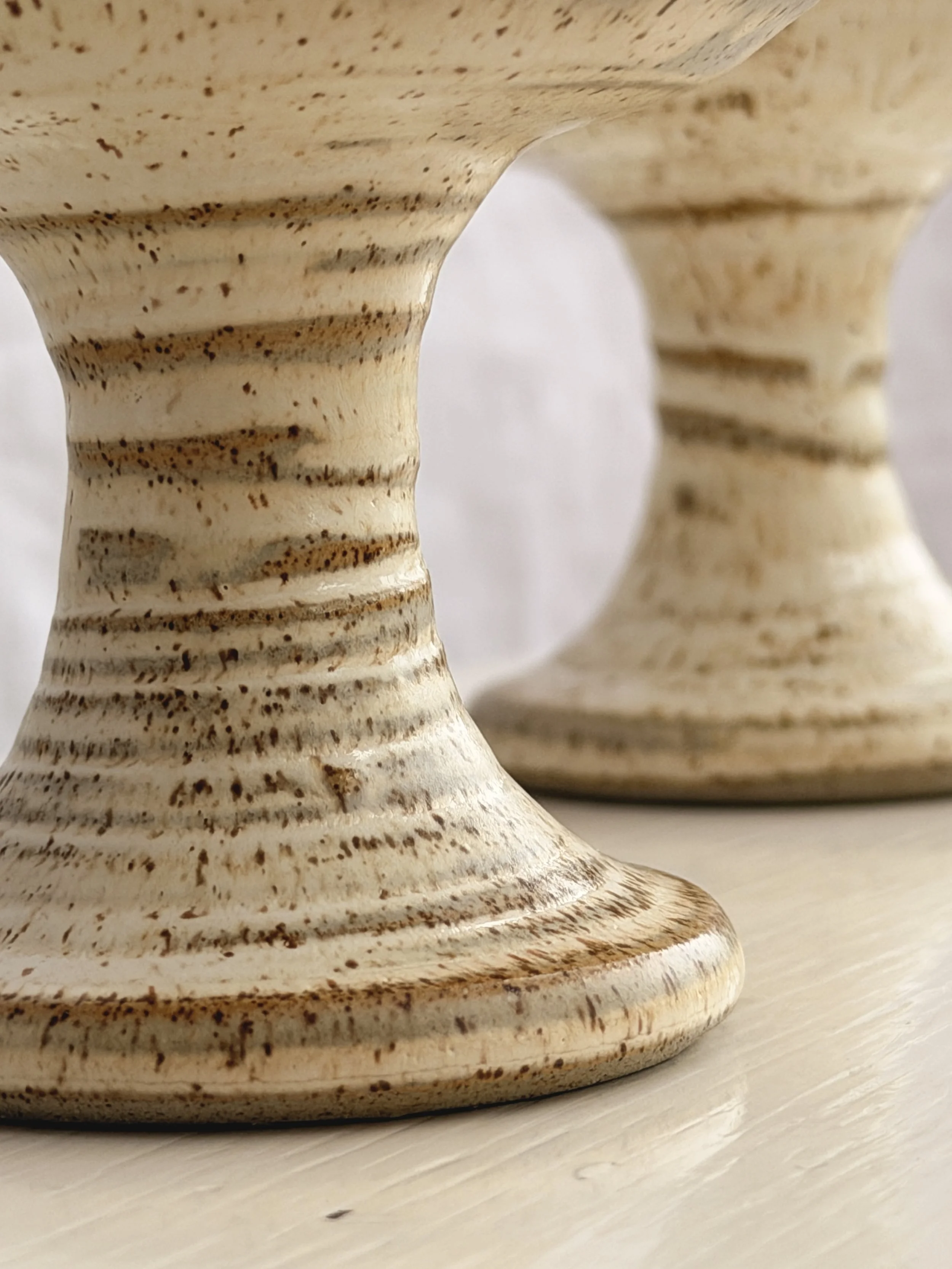 Close-up of the ribbed stem and base of a handmade Grayshott stoneware chalice.