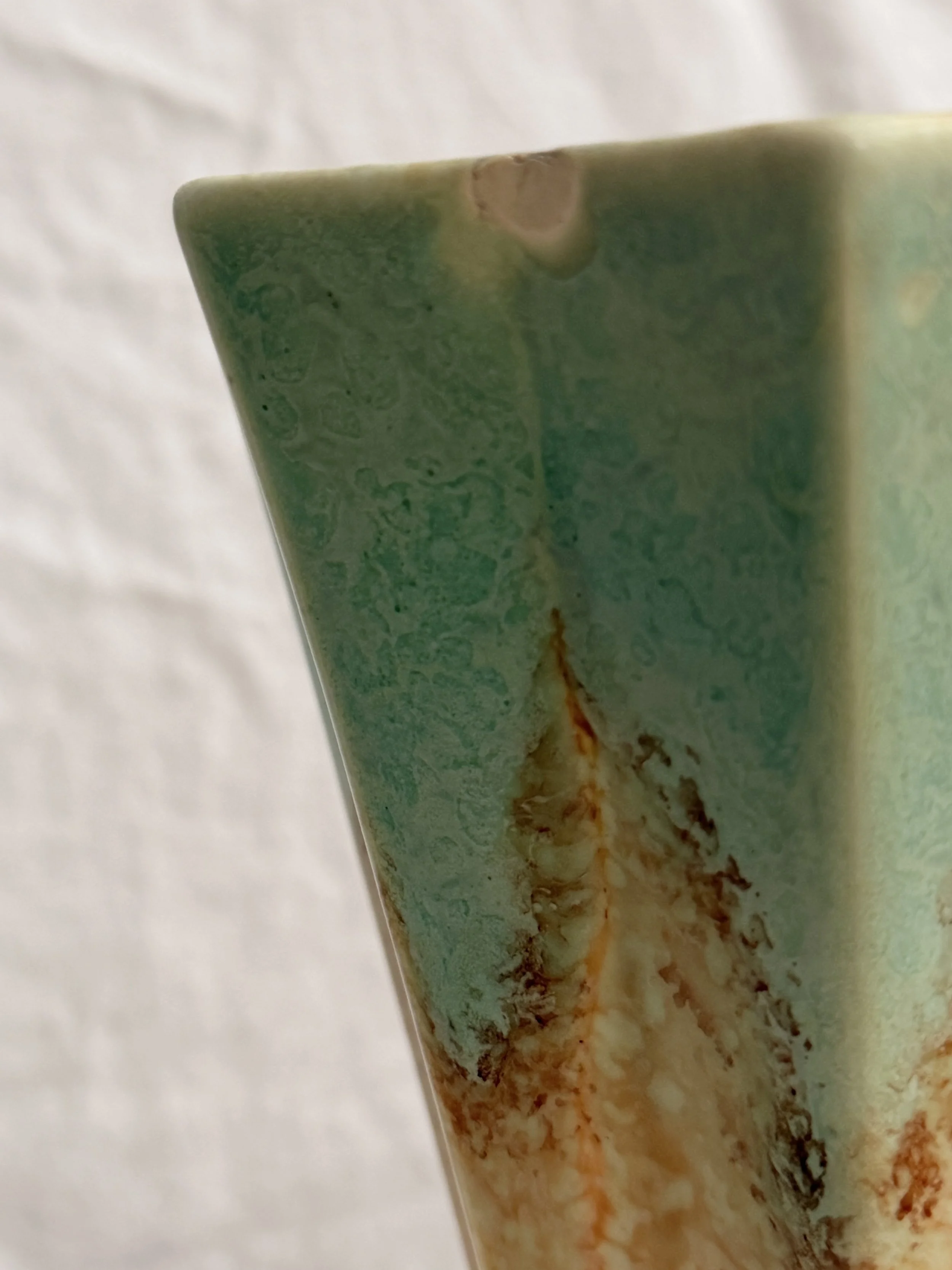 Close-up of the rim and neck with chip of a 1930s Crown Devon pottery flower vase.
