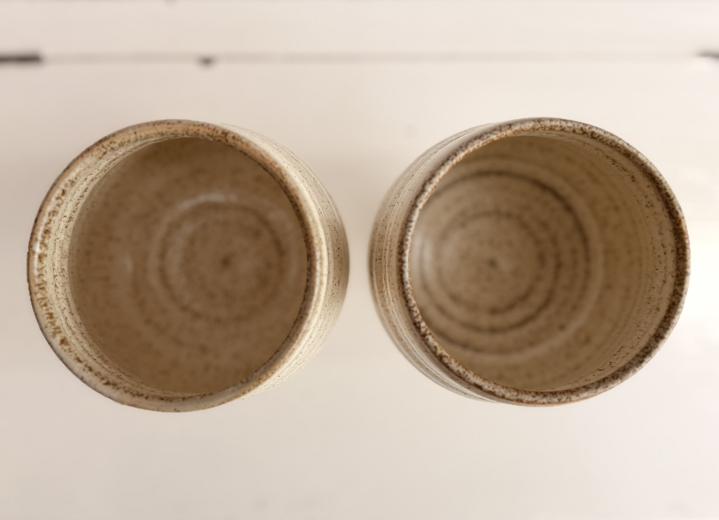Looking down into the interior of a clean, glazed stoneware wine goblet.