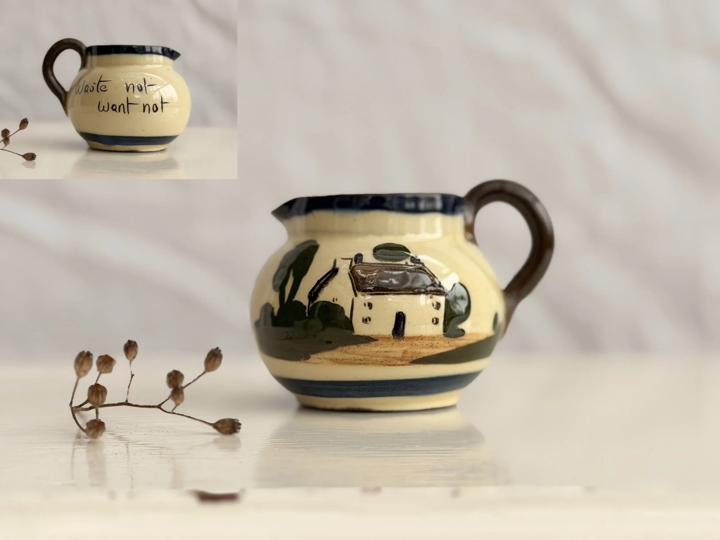 A small vintage Watcombe Pottery cream jug featuring a hand-painted English cottage scene and a traditional waste not want not motto.