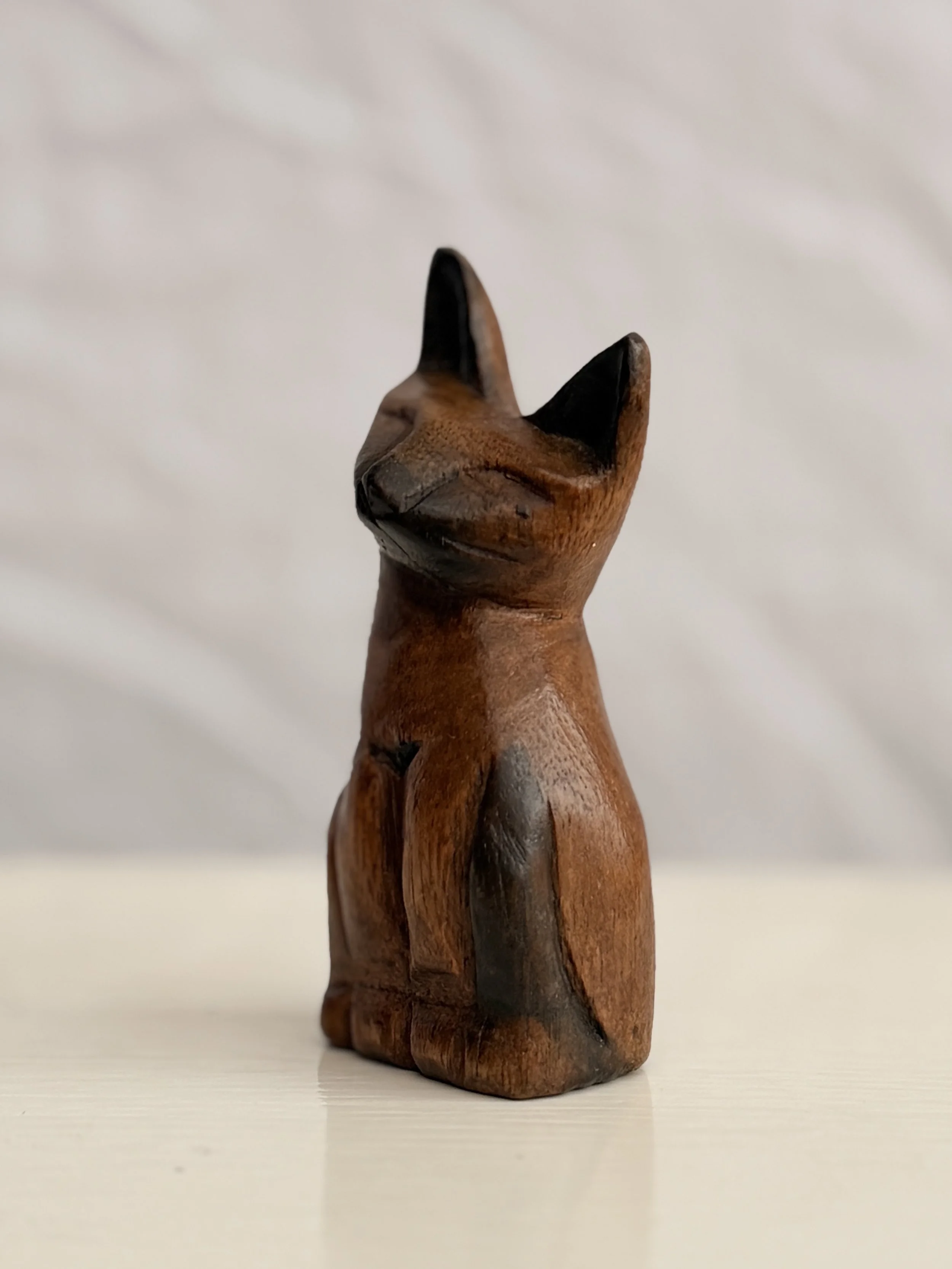 Hand-carved cat figurine with a primitive folk art aesthetic, perfect for earthy home interiors.