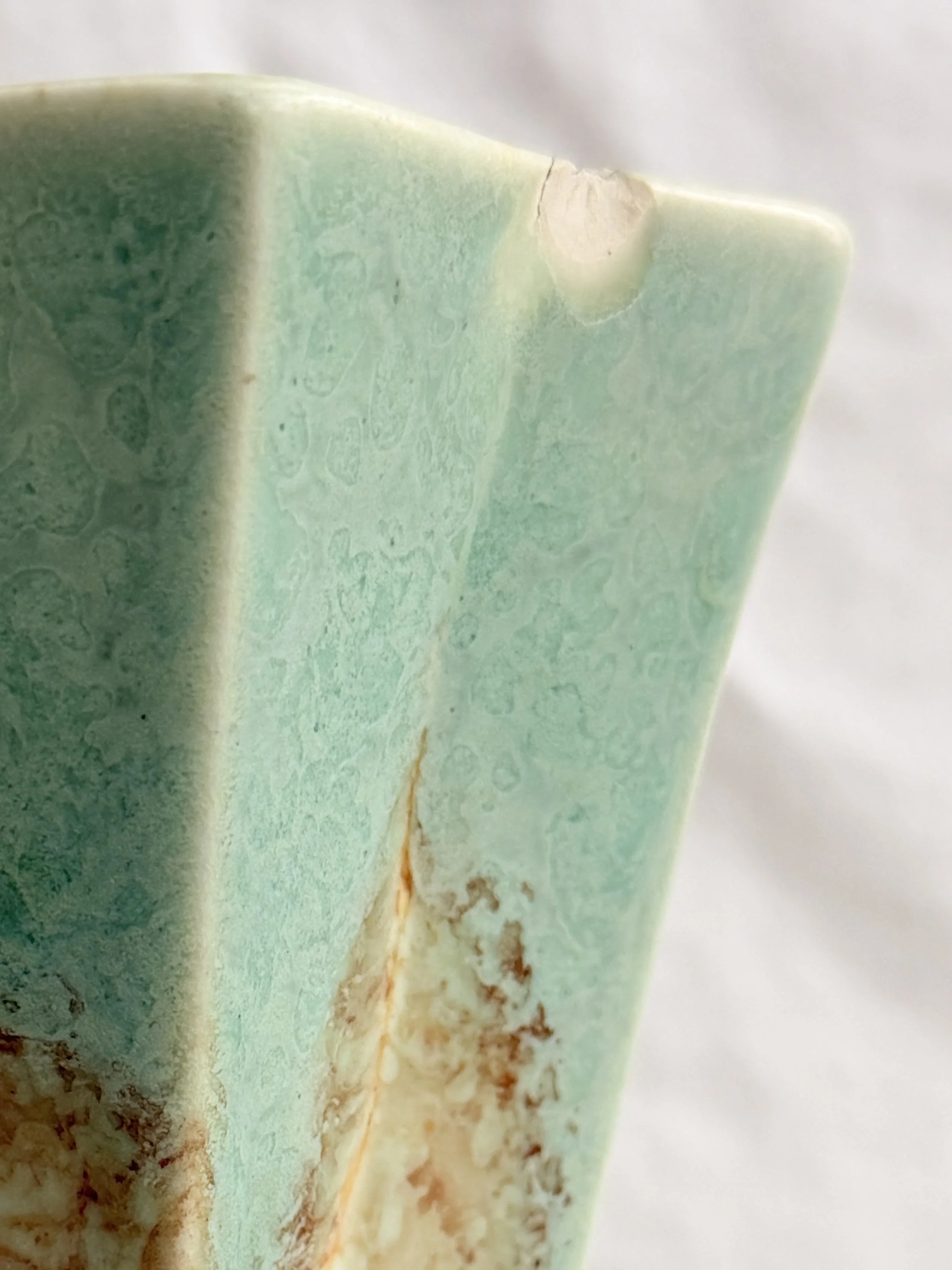 close up of chip on crown devon geometric vase