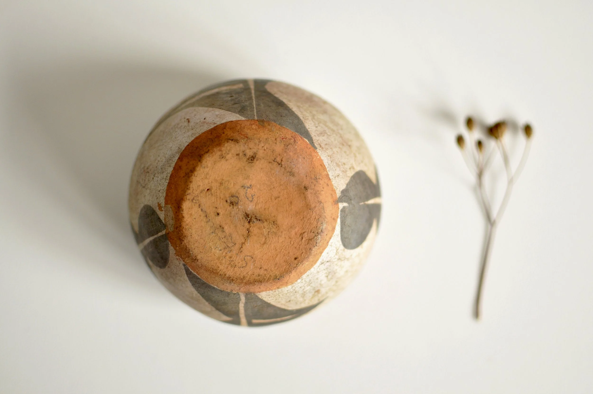 Hand-burnished base of an authentic Kewa Pueblo offerings bowl.