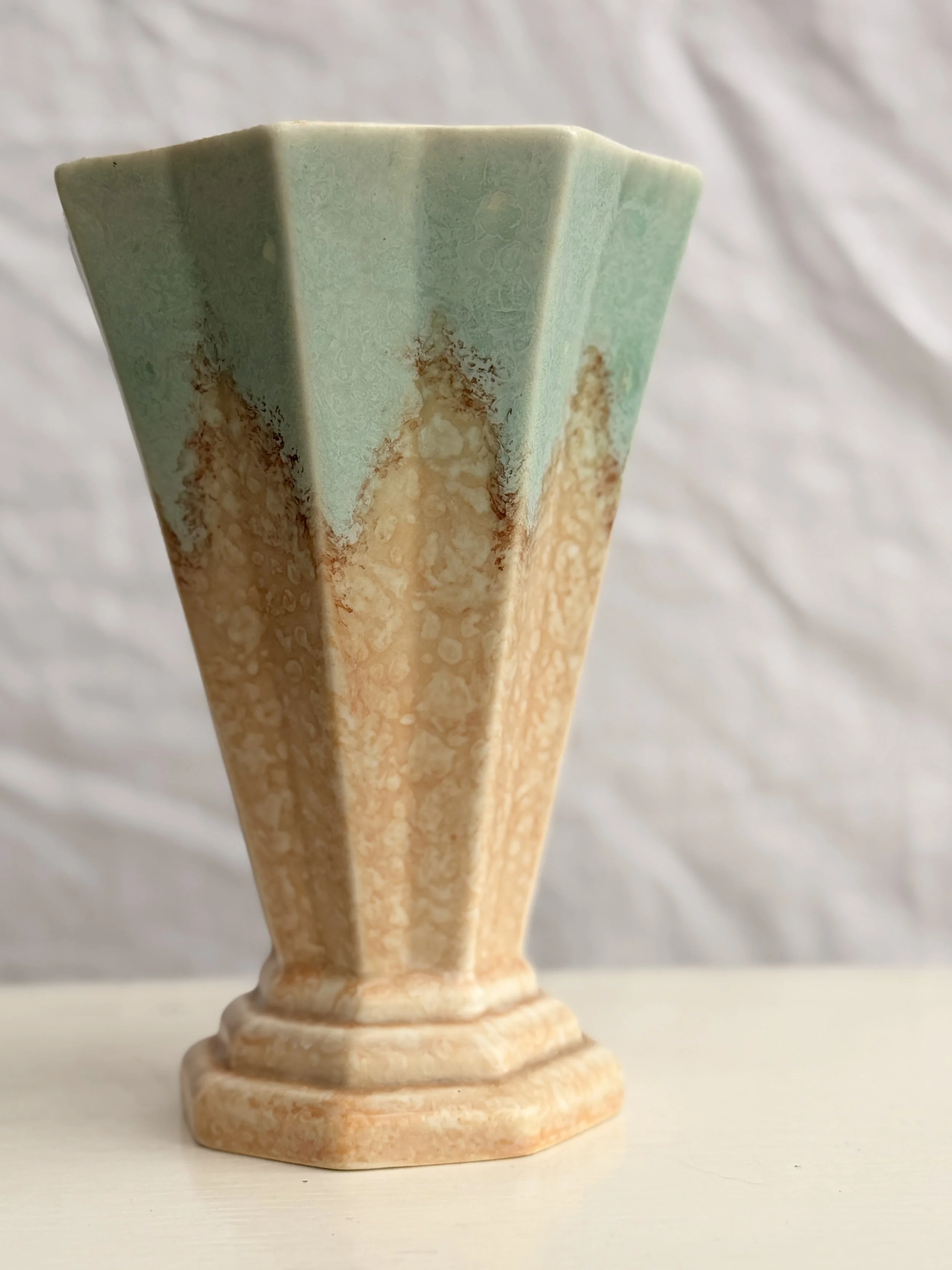 A 1930s Crown Devon Fieldings pottery vase in a soft, neutral-toned glaze.