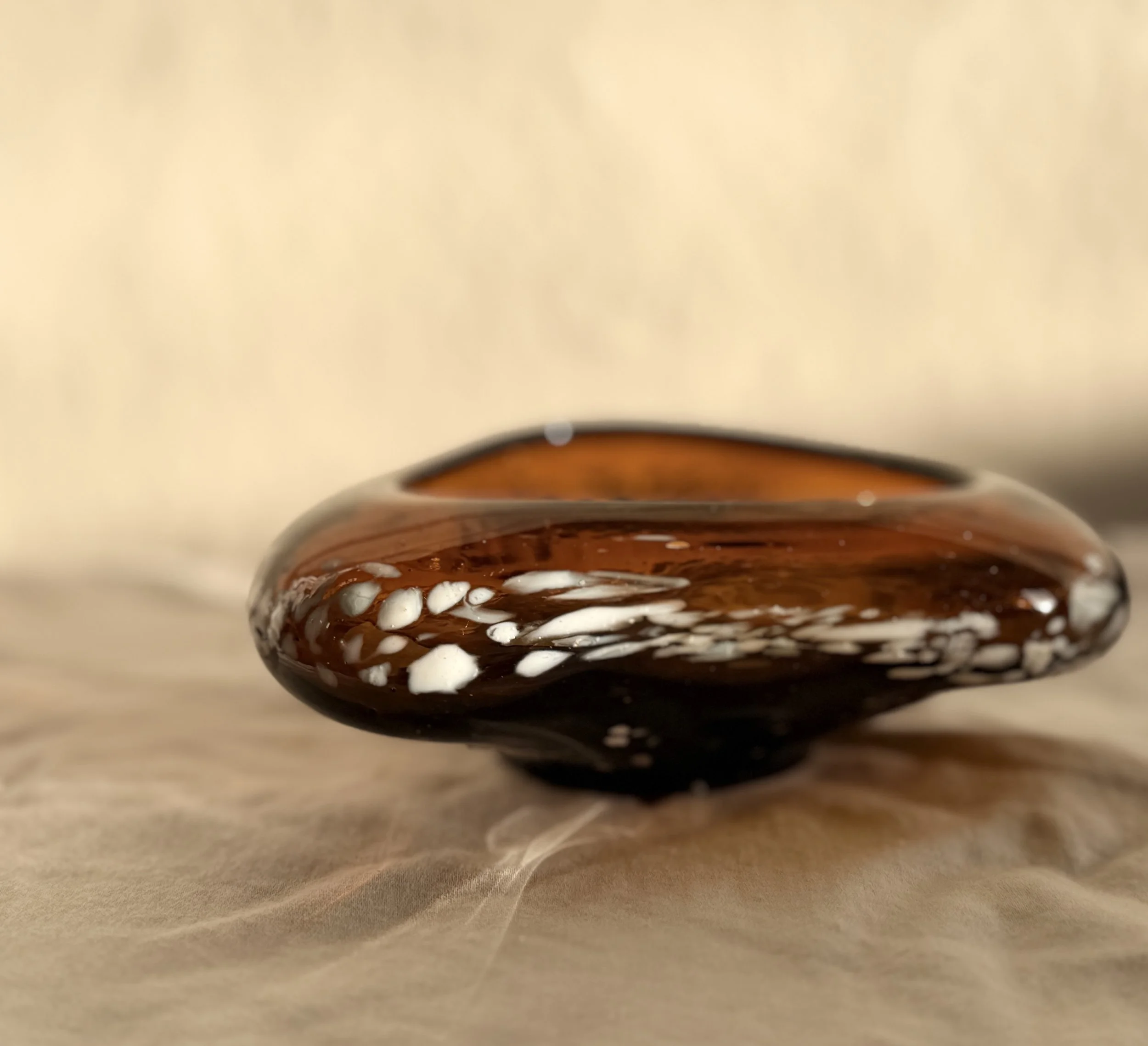 Organic modern home decor: Honey amber glass bowl with a unique textured white frit design.