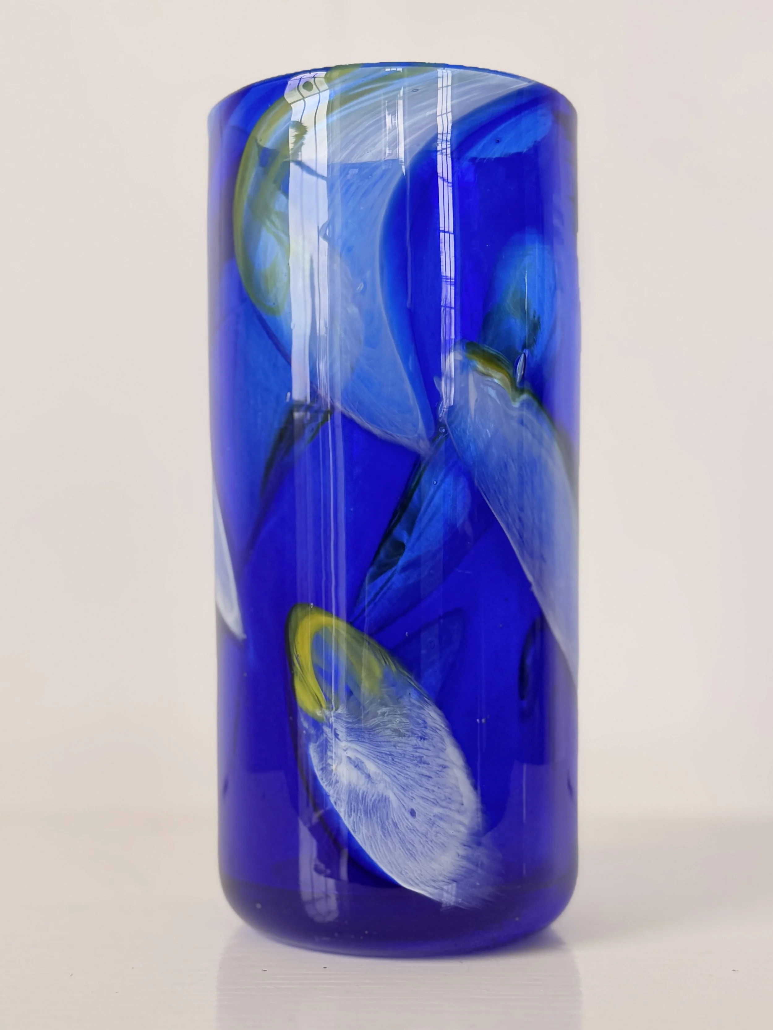 Close-up of the hand-blown glass texture showing tiny unique air bubbles within the deep blue hue.