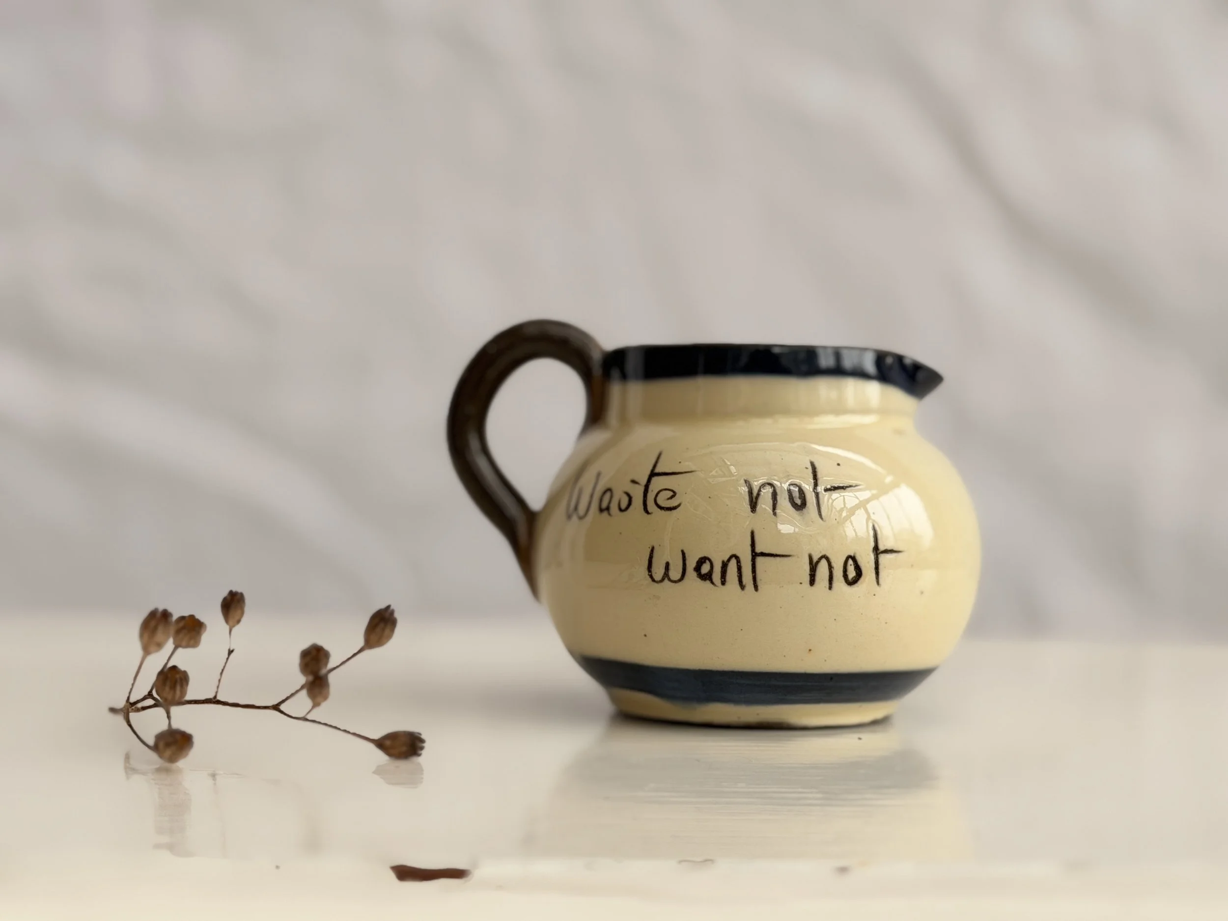 mini folk art jug with waste not want not sustainable motto