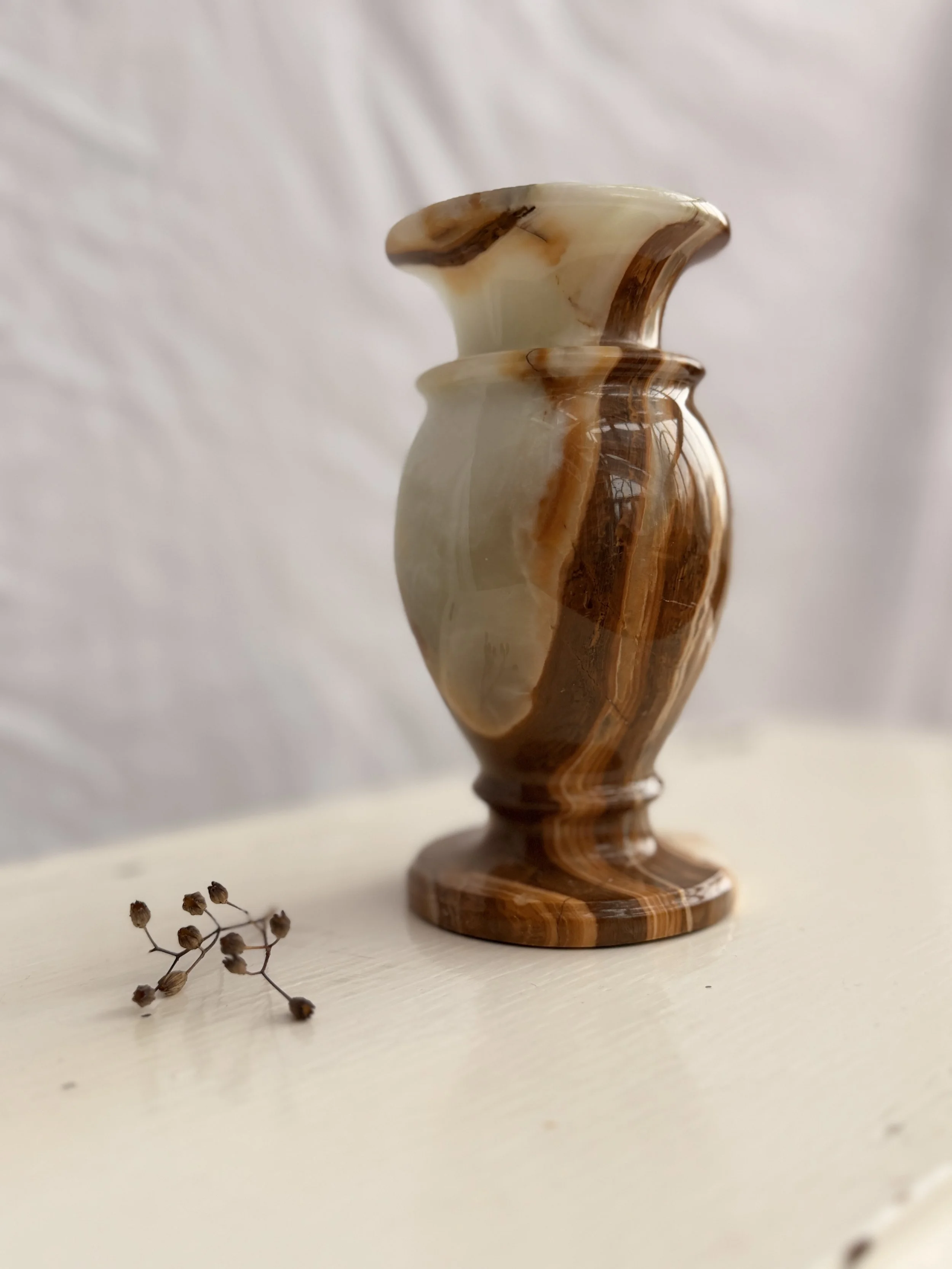 Hand-carved 15cm onyx vase with a polished finish, showing beautiful organic horizontal banding.