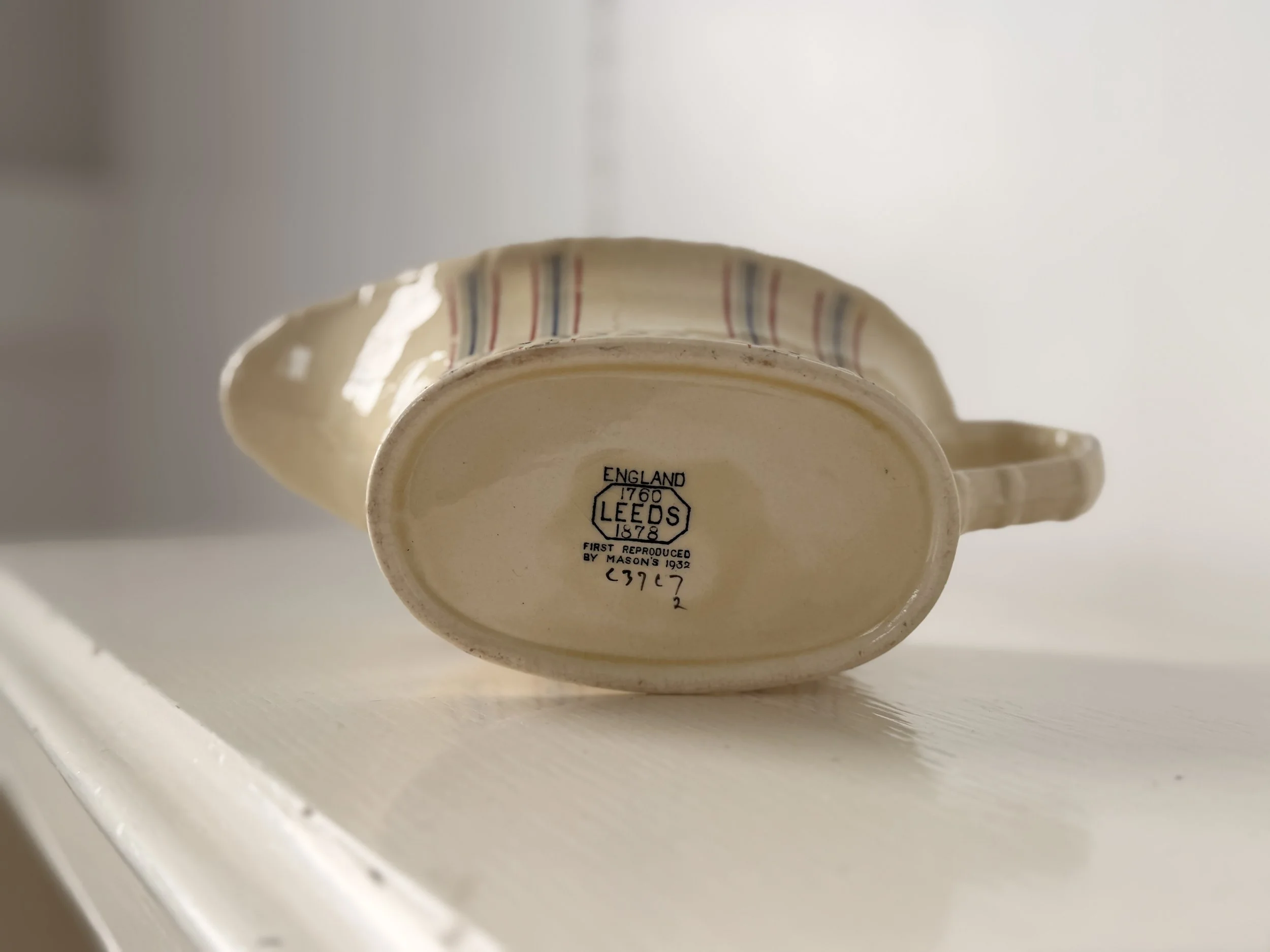 close up of makers mark stamp on underside of jug