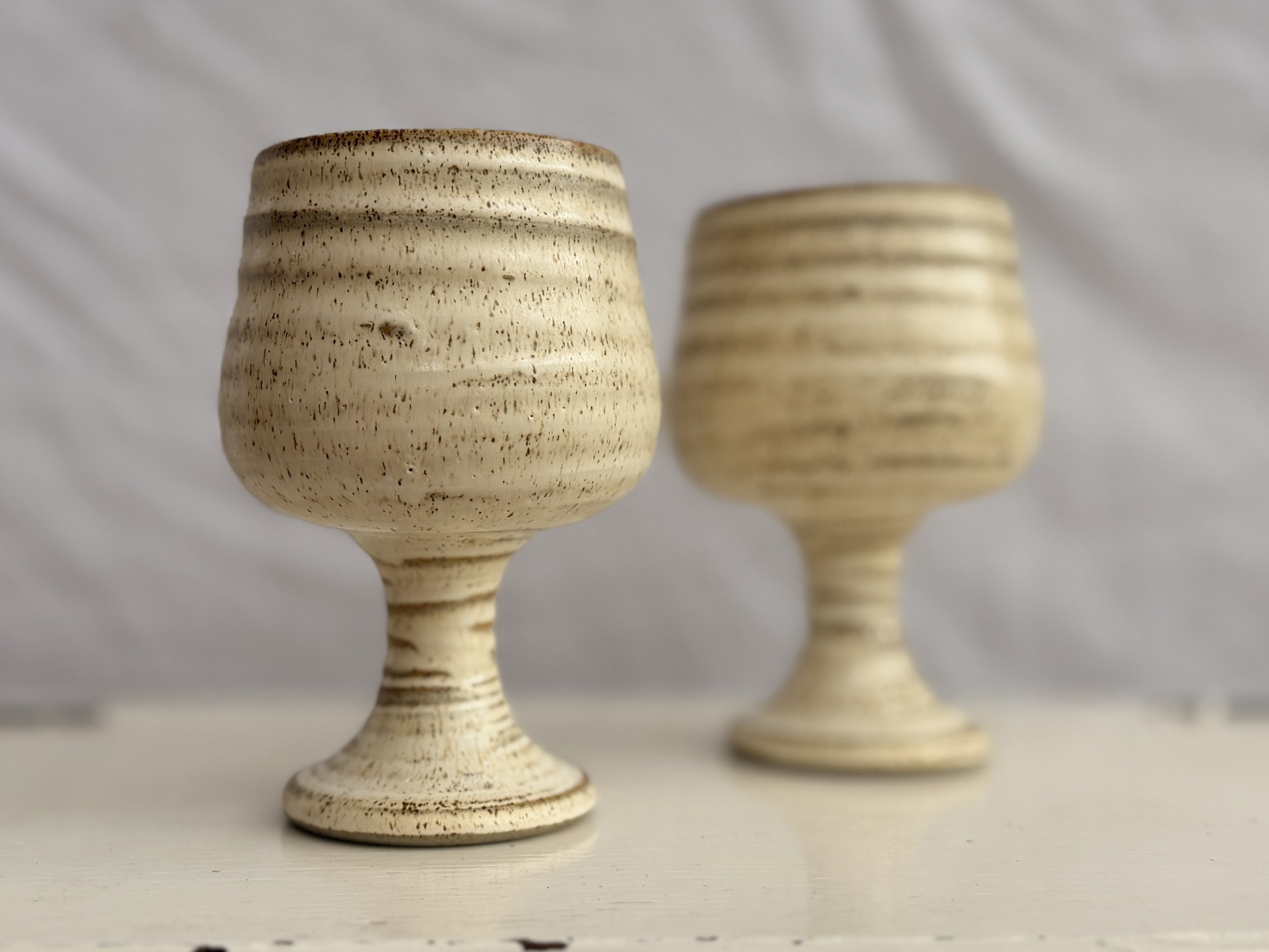 A pair of vintage Grayshott Pottery stoneware goblets in a speckled neutral glaze