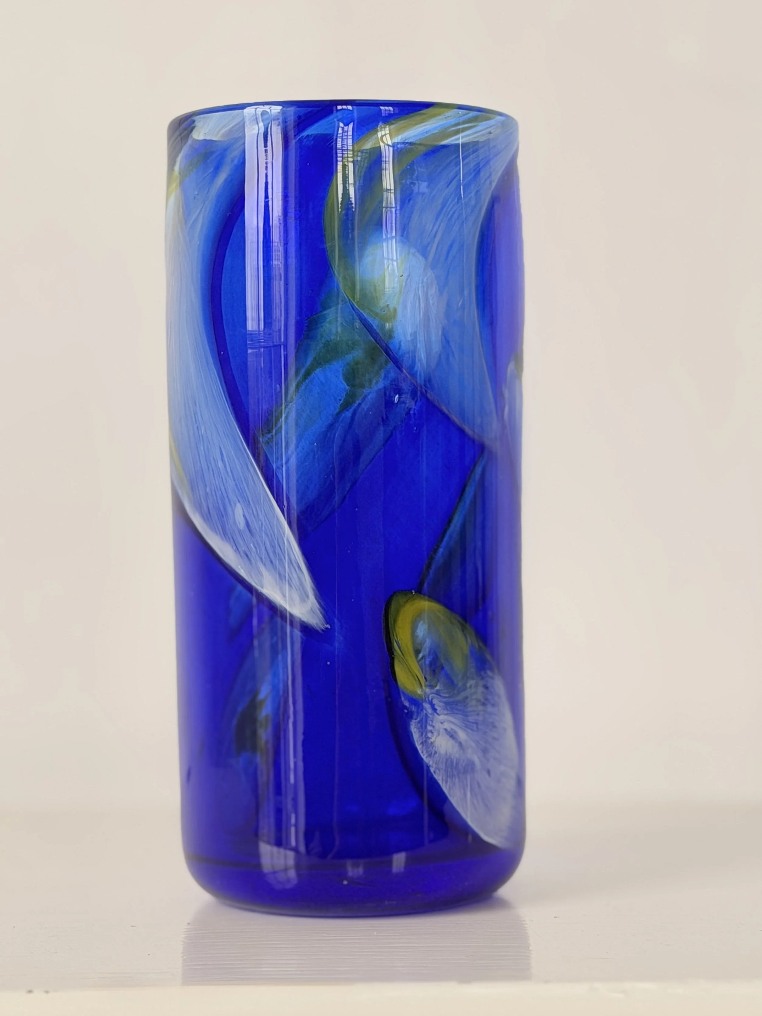 Close-up of the hand-blown glass texture showing tiny unique air bubbles within the deep blue hue