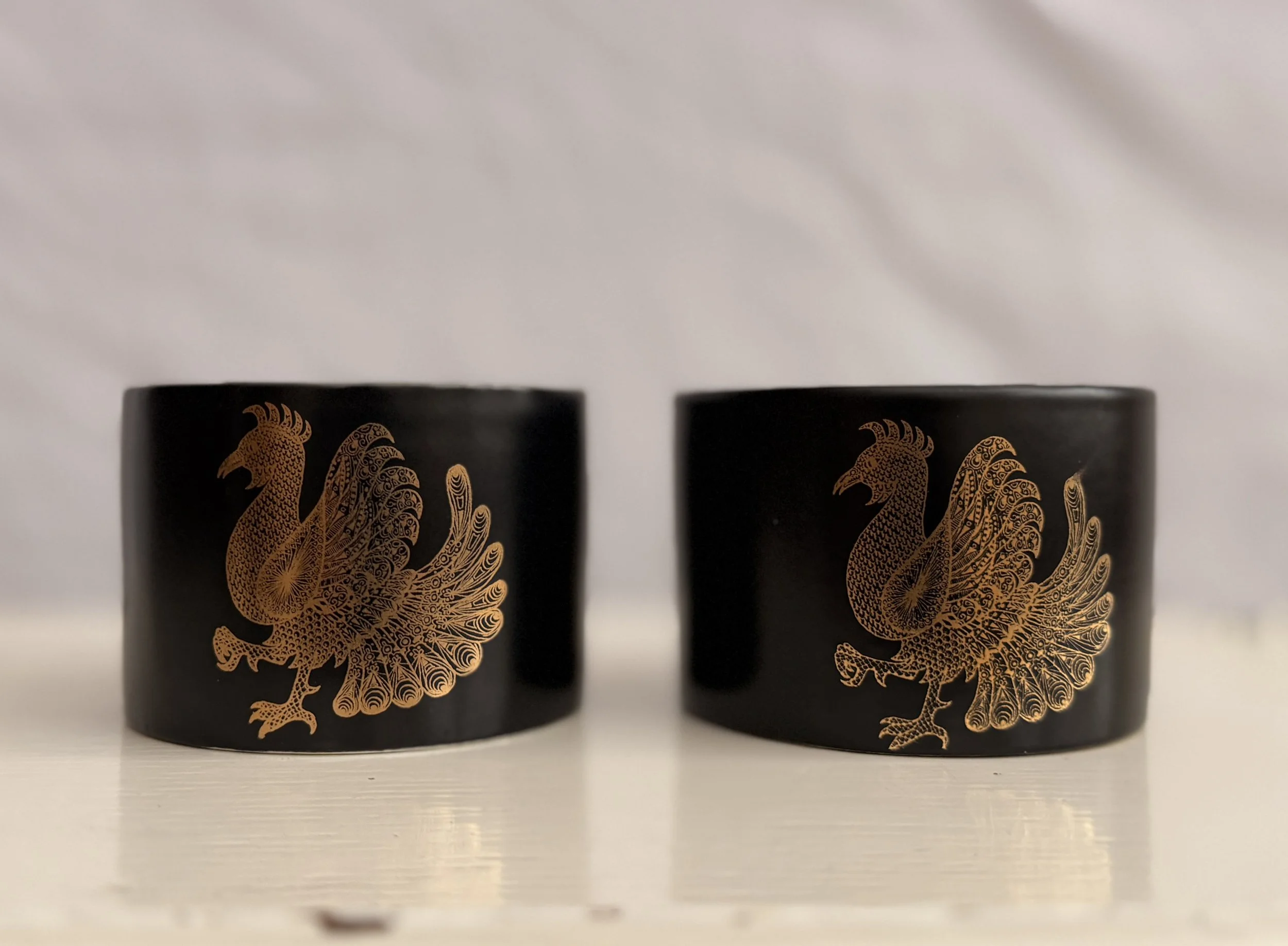 A pair of John Cuffley designed Portmeirion Phoenix sugar bowls in black and gold.