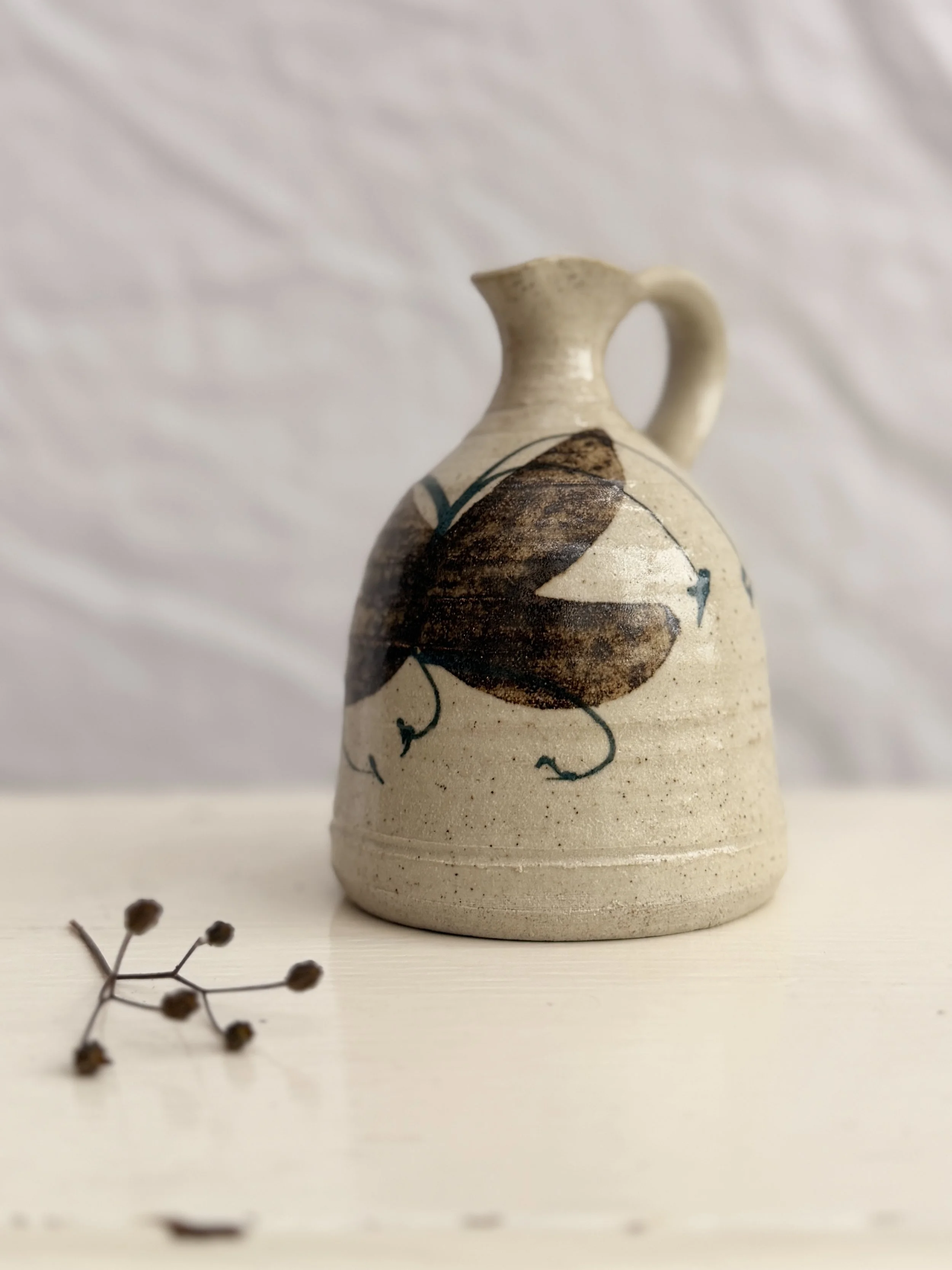 Vintage Rashleigh Pottery jug from Cornwall, featuring a hand-painted floral or leaf design on oatmeal stoneware.
