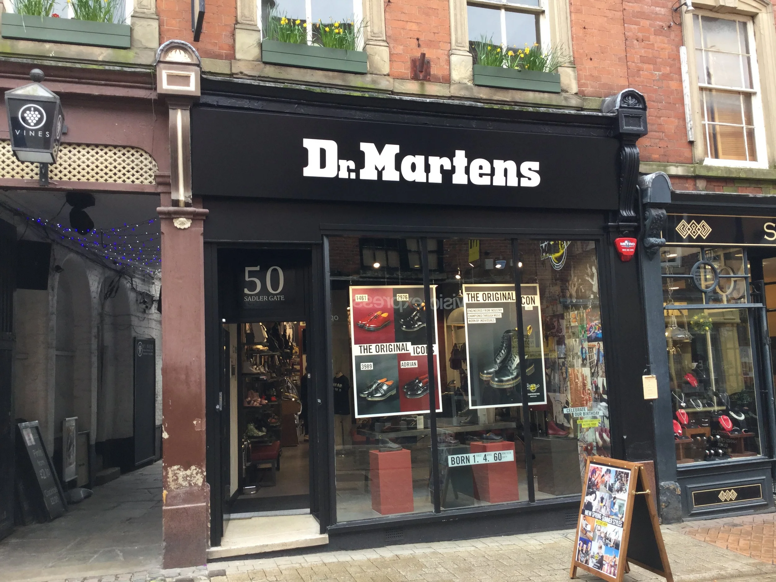 Dr. Martens shoe store exterior with signage and display, located on Sadler Gate, featuring storefront window displays and street view.