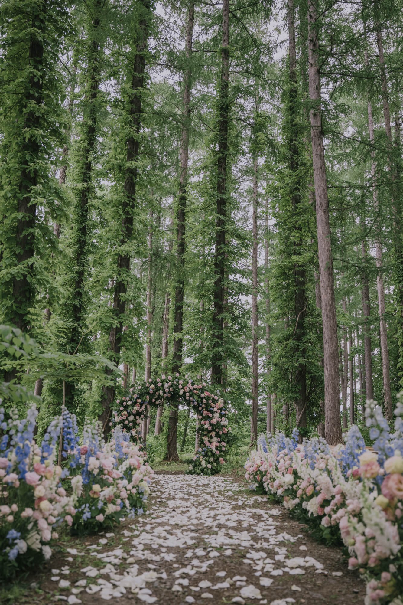 Floral wedding aisle with tall trees