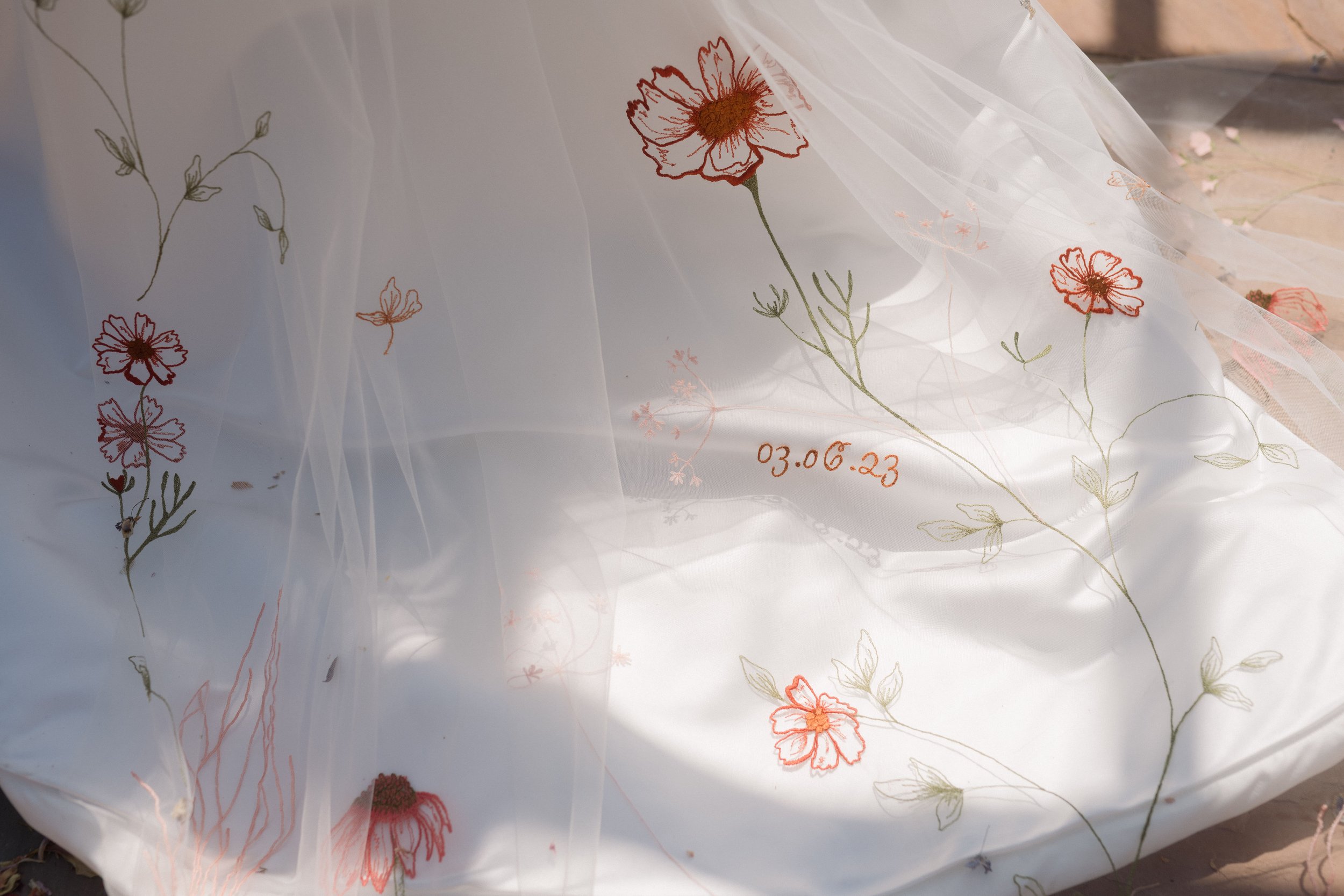  Embroidered veil against train of wedding dress 