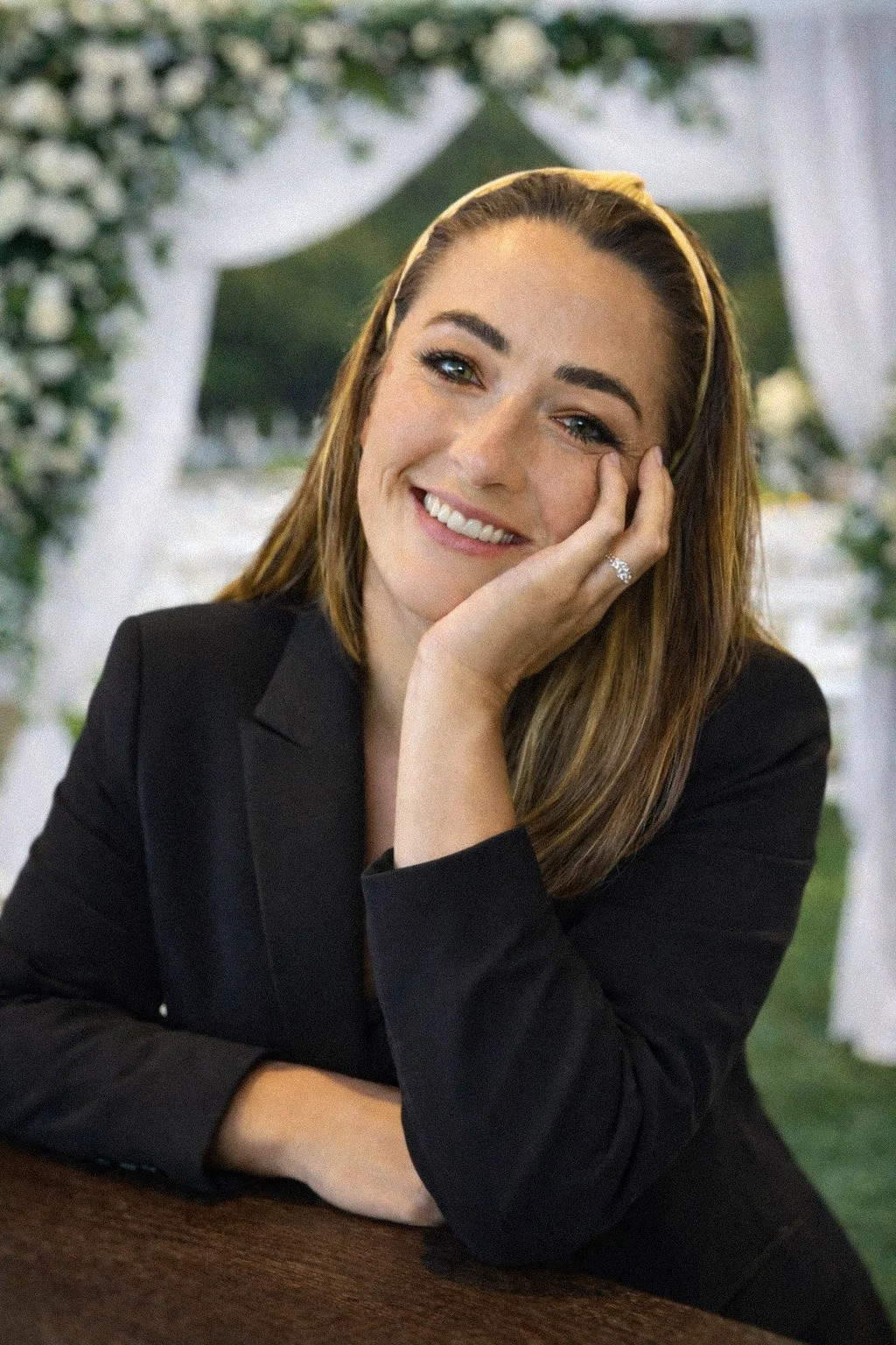 A woman at a wedding posing for the camera