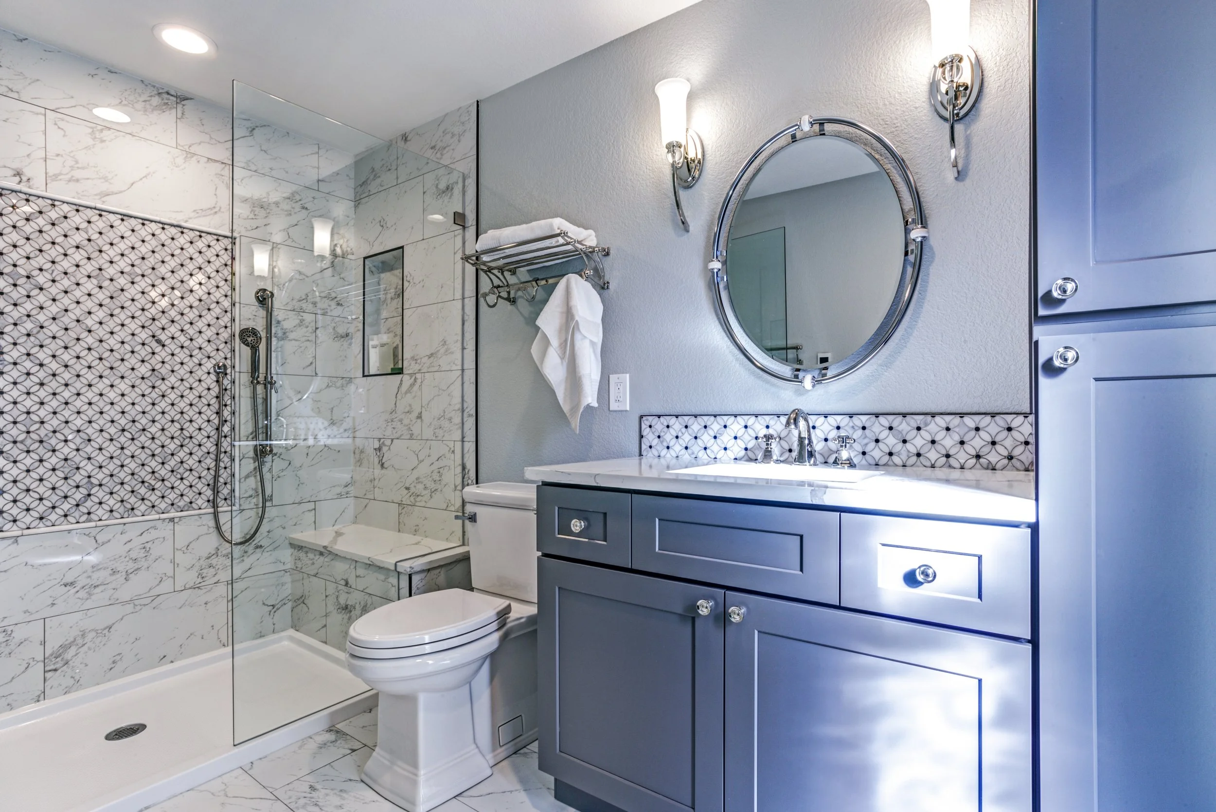 bathroom remodel, White marble tile, bathroom shower, tile shower, shower pan, shower bench, frameless shower door, blue shaker style cabinets, vanity cabinet, Denver, Littleton, Aurora, Centennial, Parker, Colorado  