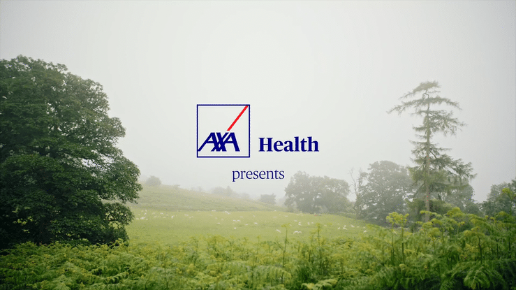 AXA Health logo over a scenic background of green trees and a grassy field in foggy weather.