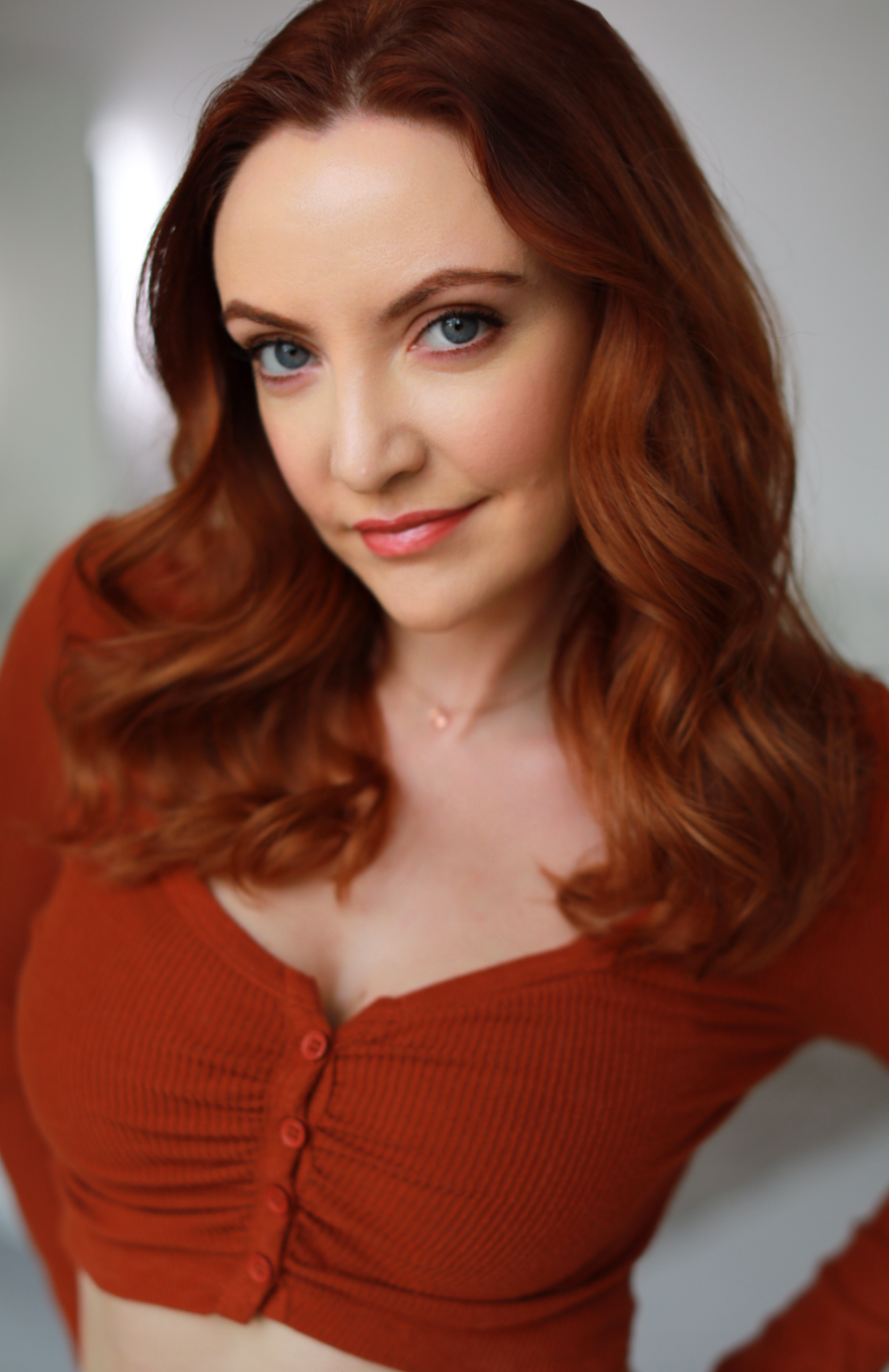 Sarah Street Head Shot orange shirt.png