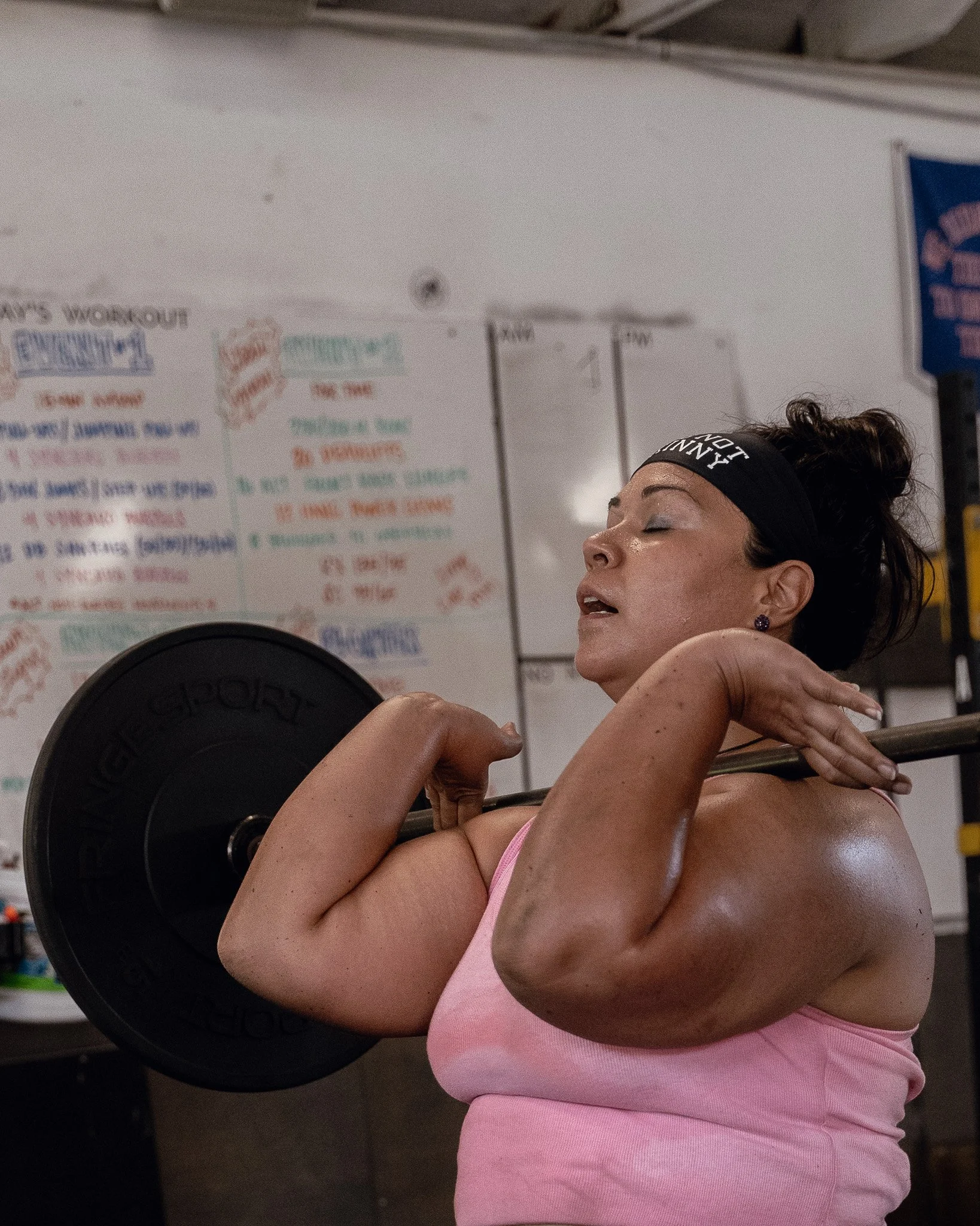 Woman with a barbell in the front rack position