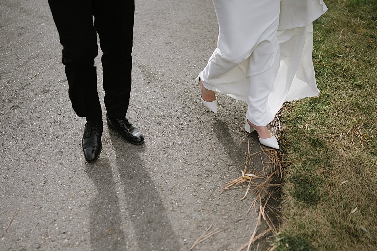 Bridge and groom shoes walking on a path