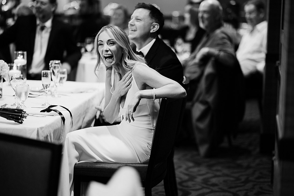 Wedding guests laughing together while posing for modern photo booth portraits at Delta Hotel Kamloops reception