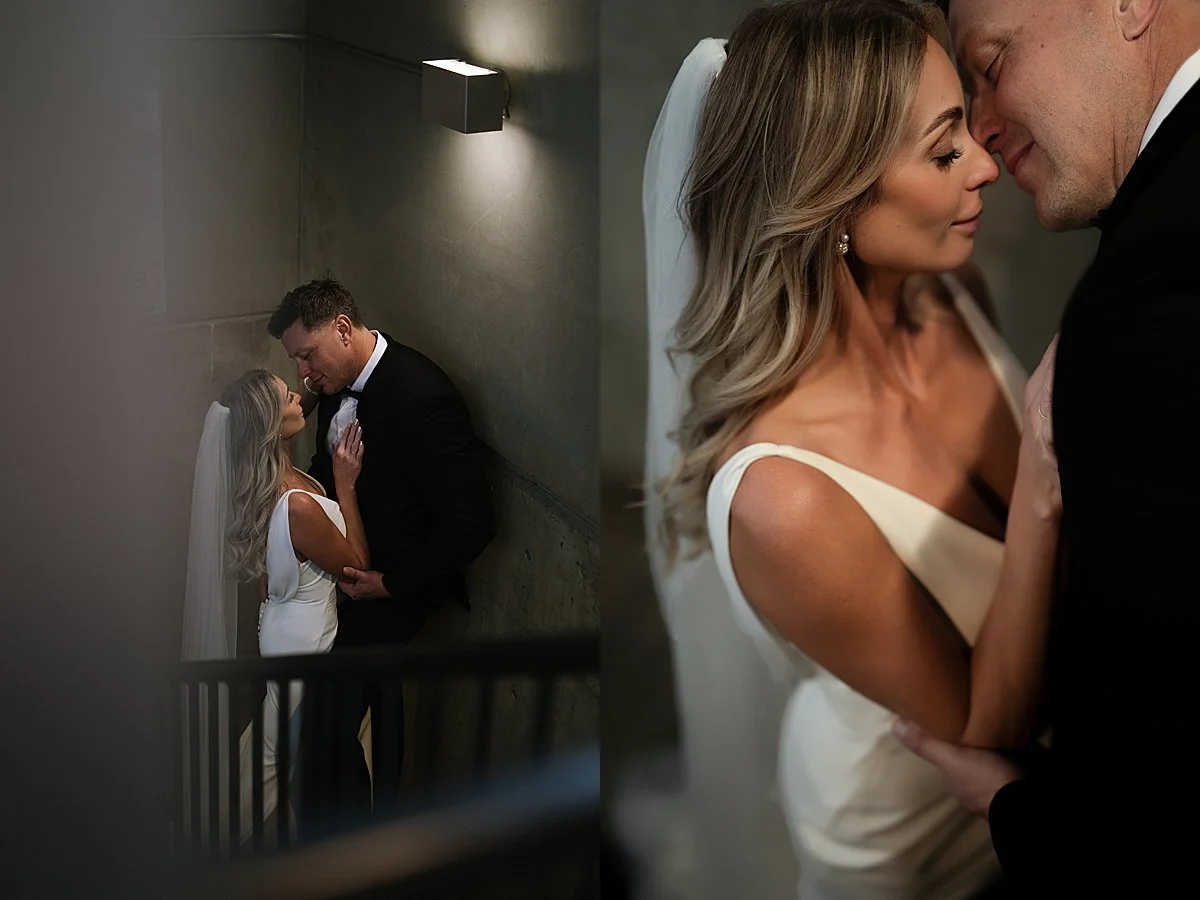 A hallway kiss between the bride and groom