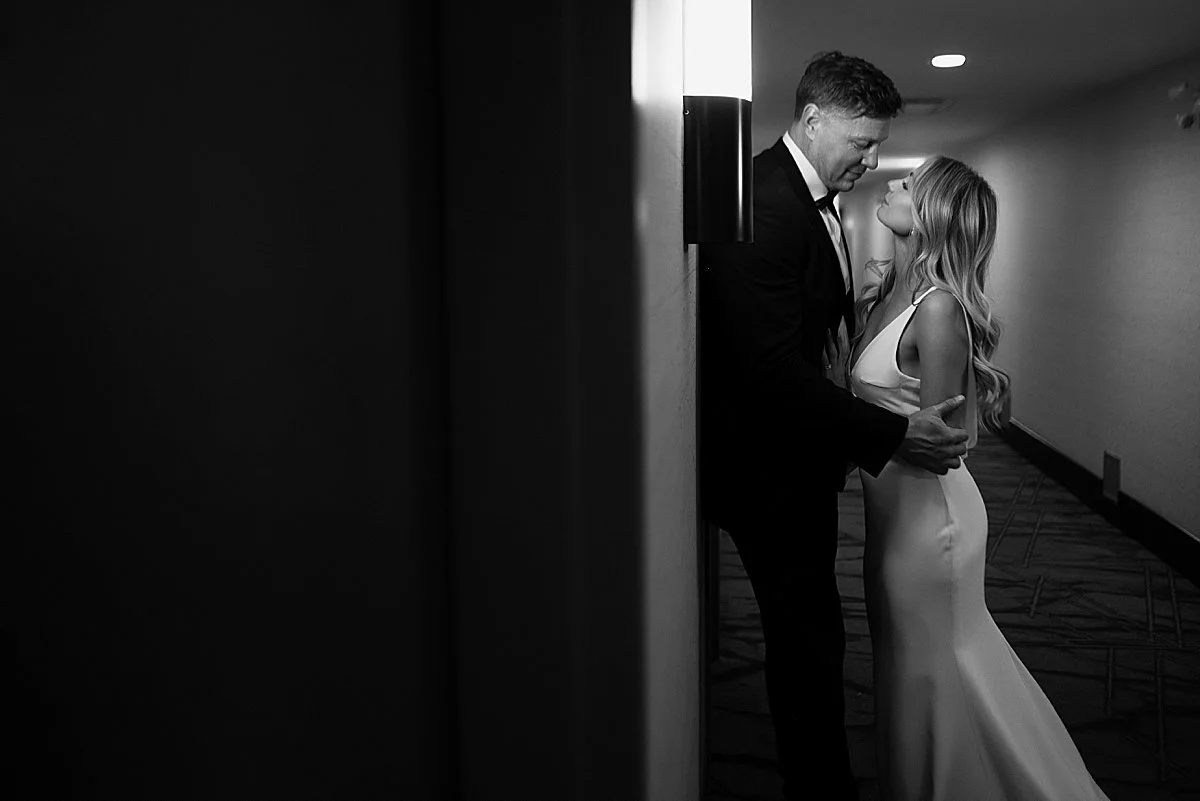 wedding couple sneaking off for intimate photos in hallway on their wedding night in kamloops